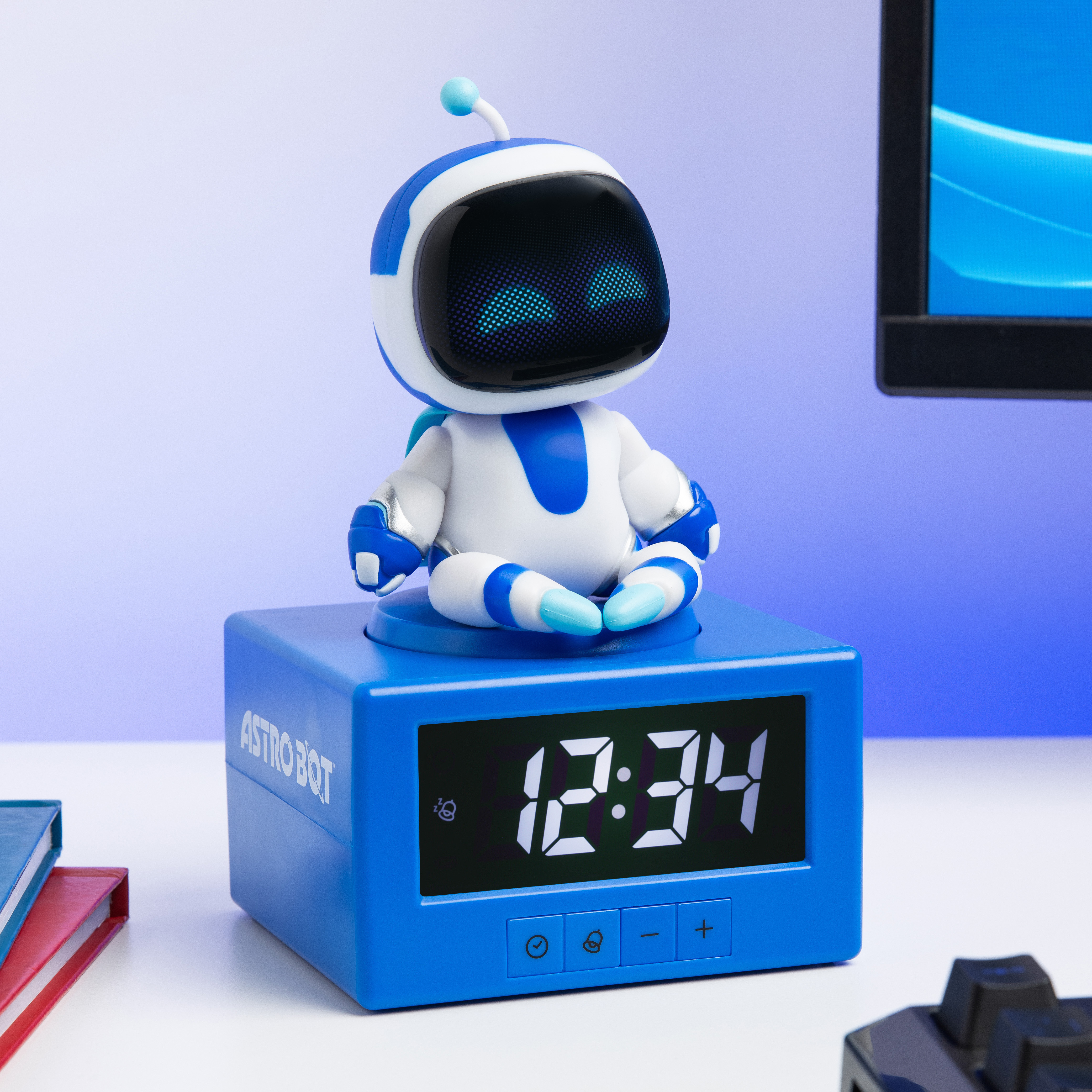 Ein blauer AstroBot sitzt auf einem blauen Wecker, der 12:34 anzeigt.