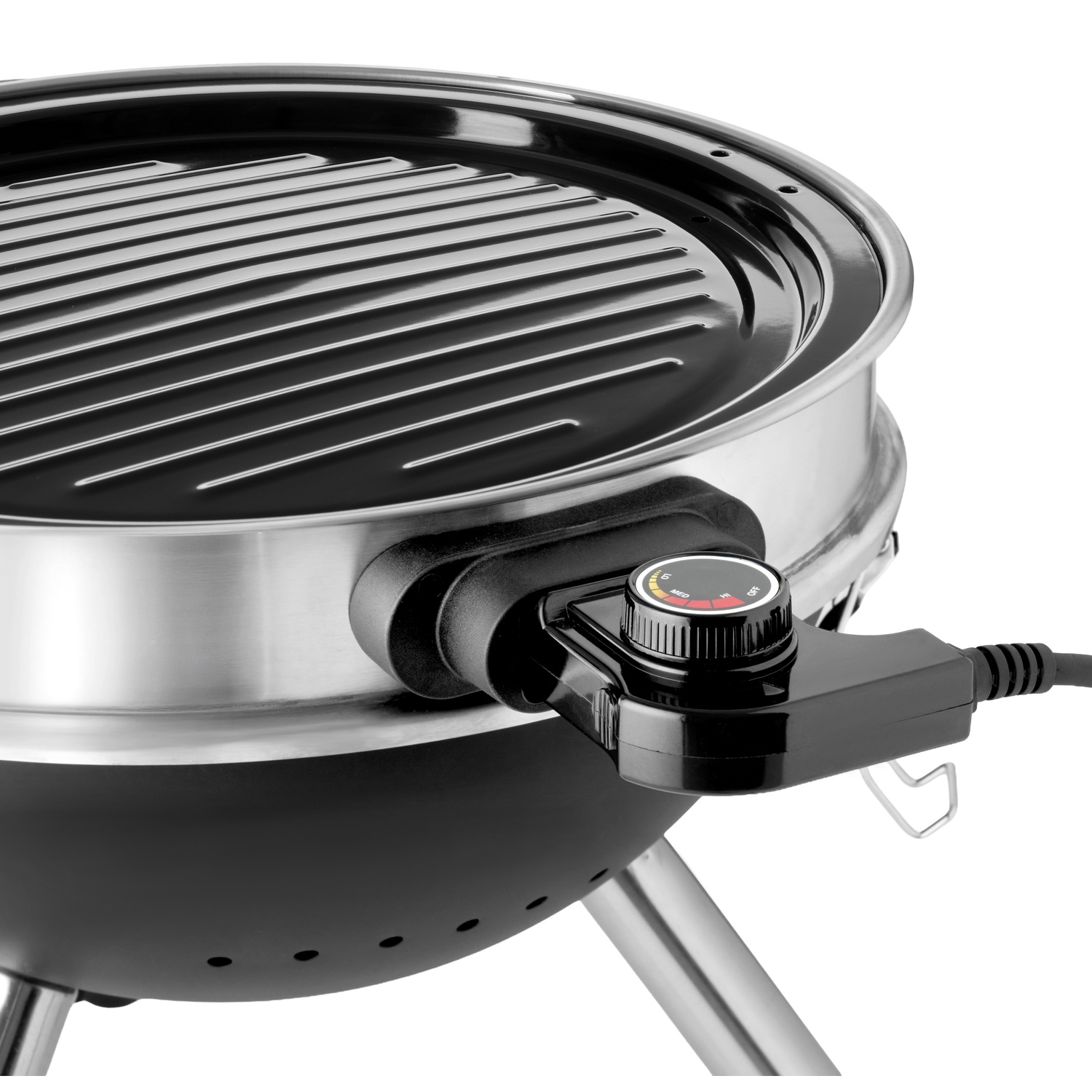 Close-up of a black and silver electric grill with a ribbed cooking surface and temperature dial.