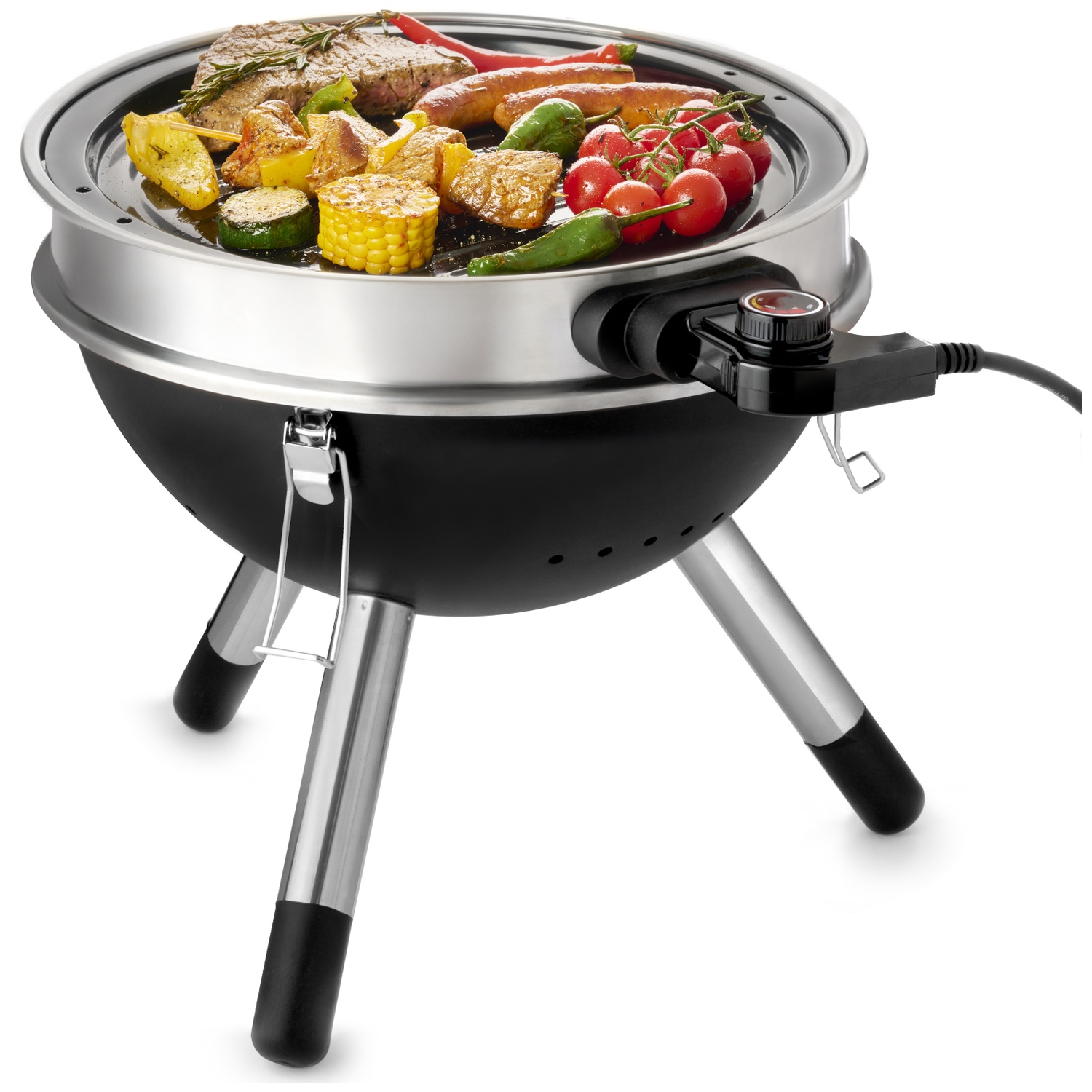 A round electric grill with meat, sausages, corn, tomatoes, and zucchini.