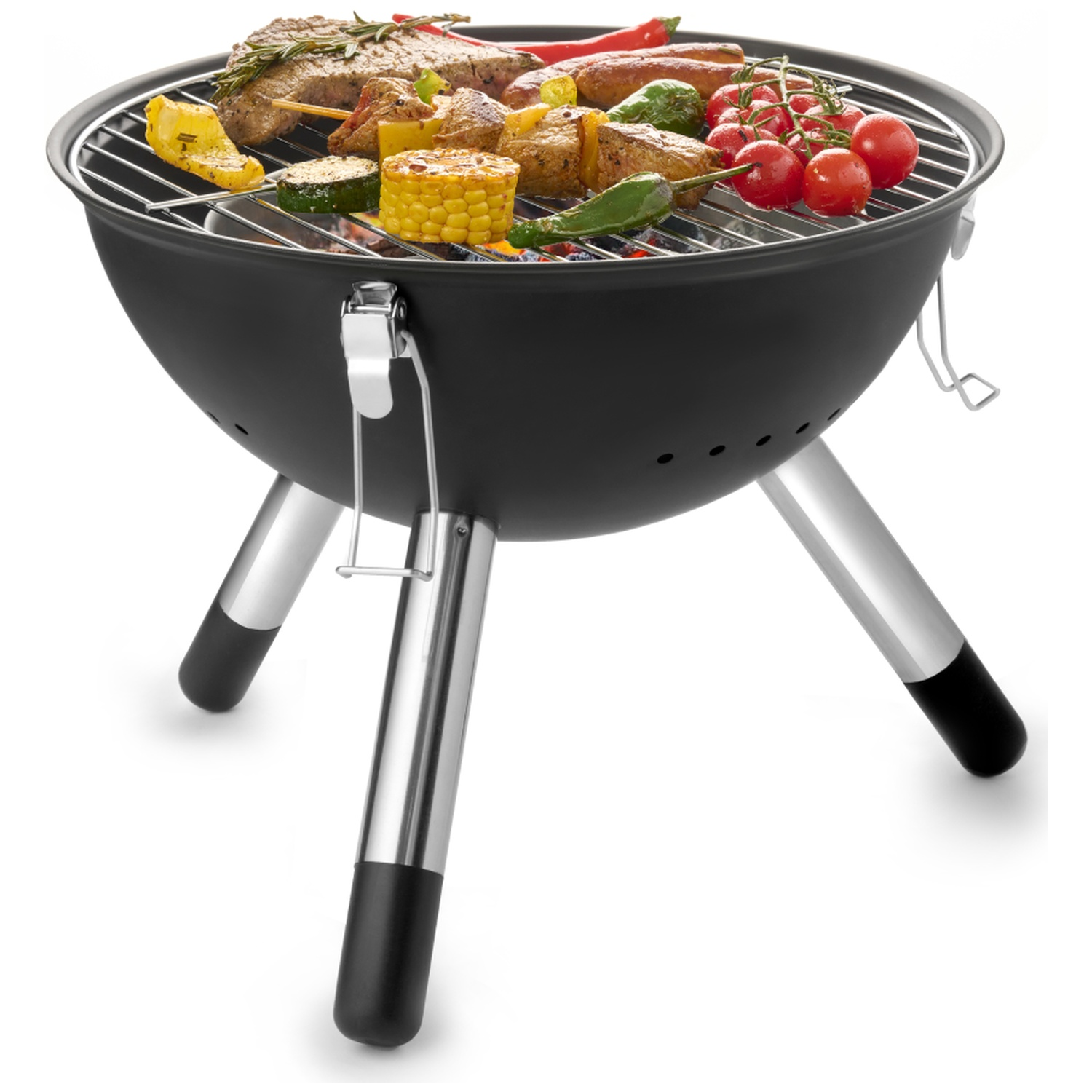 A black charcoal grill filled with various grilled foods like steak, corn, and tomatoes.