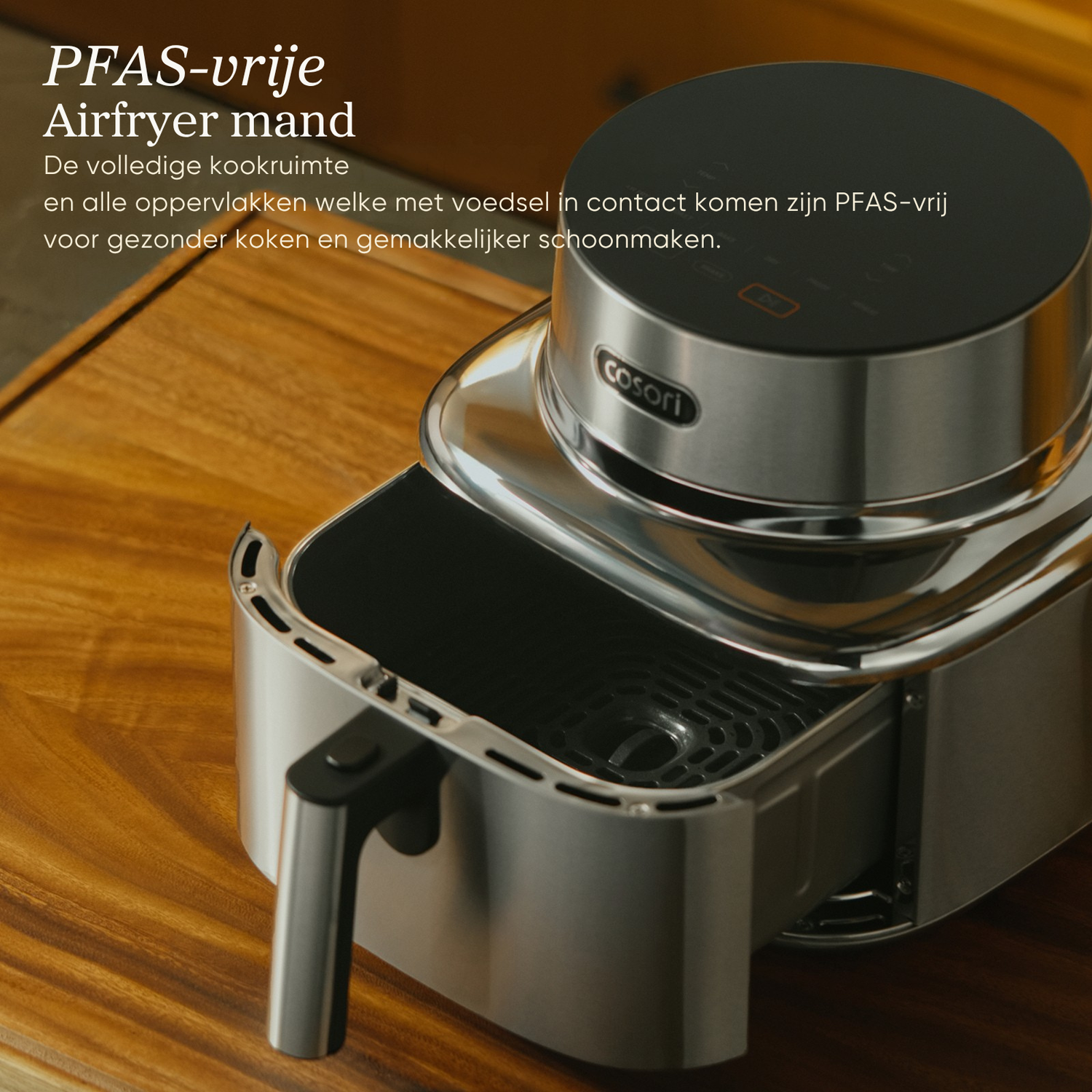 A silver Cosori air fryer with a black control panel on a wooden table.