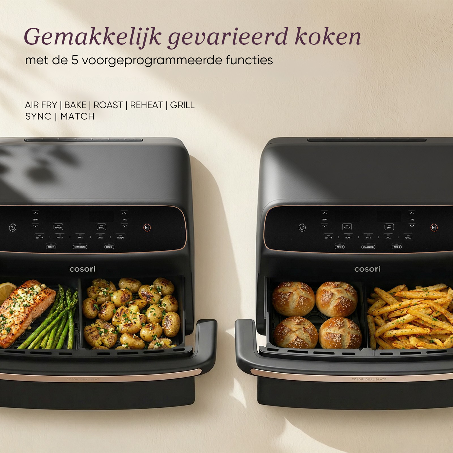 Twee Cosori airfryers, één met zalm, asperges en aardappelen, de ander met broodjes en friet.