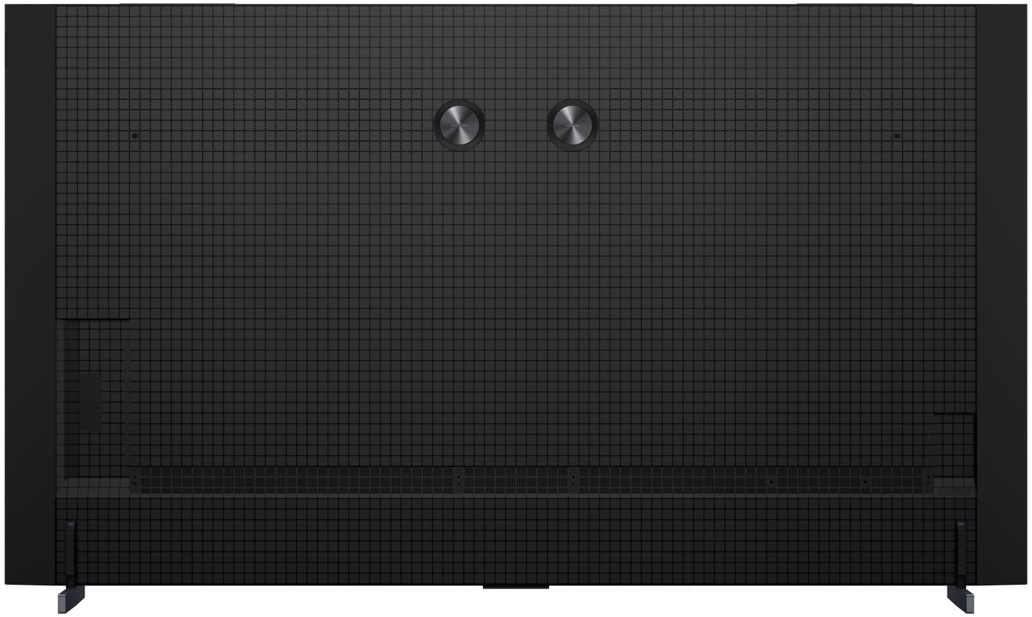 Parte trasera de un televisor negro con patrón de rejilla y dos puertos redondos plateados.
