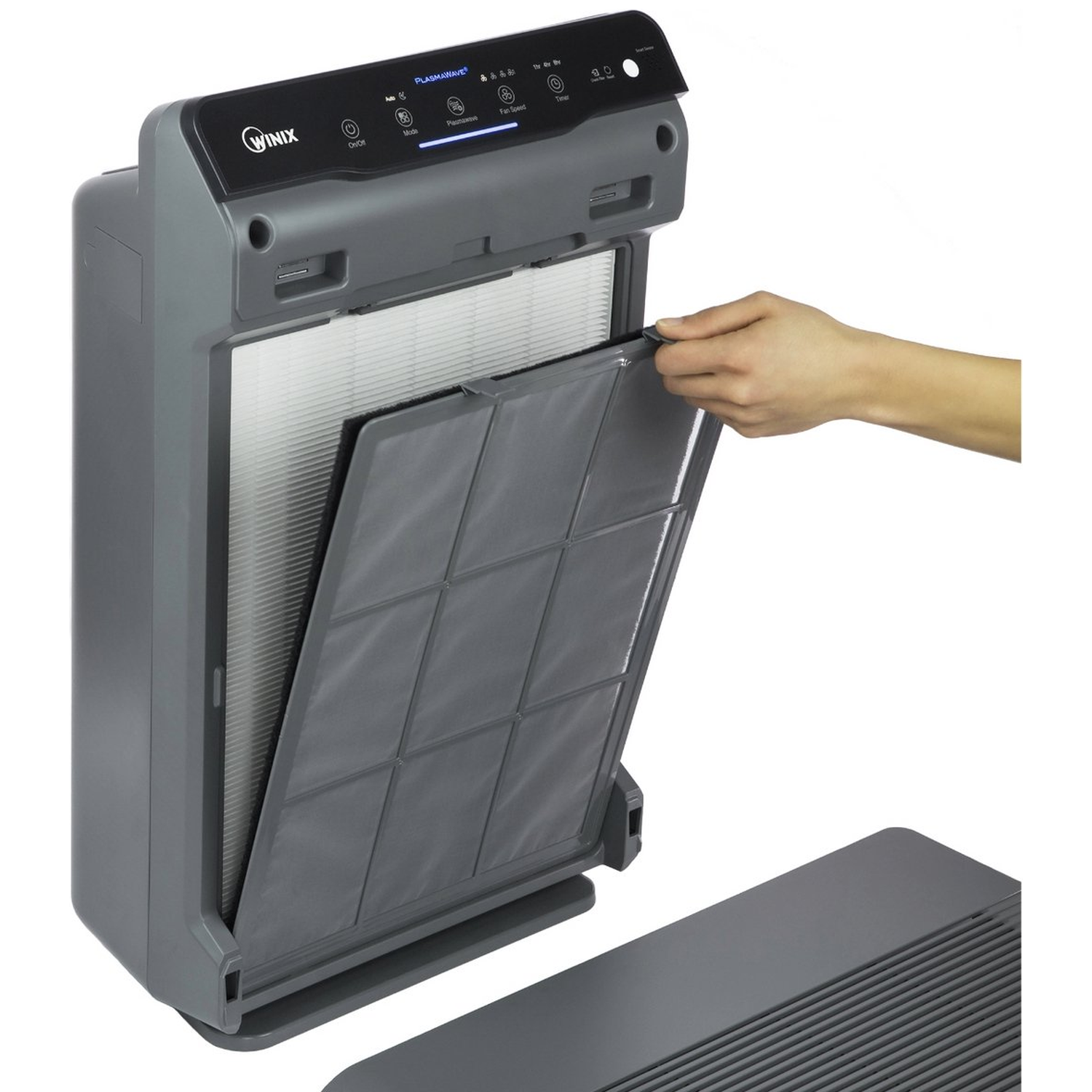 A hand pulls a gray filter from an air purifier with a display panel.