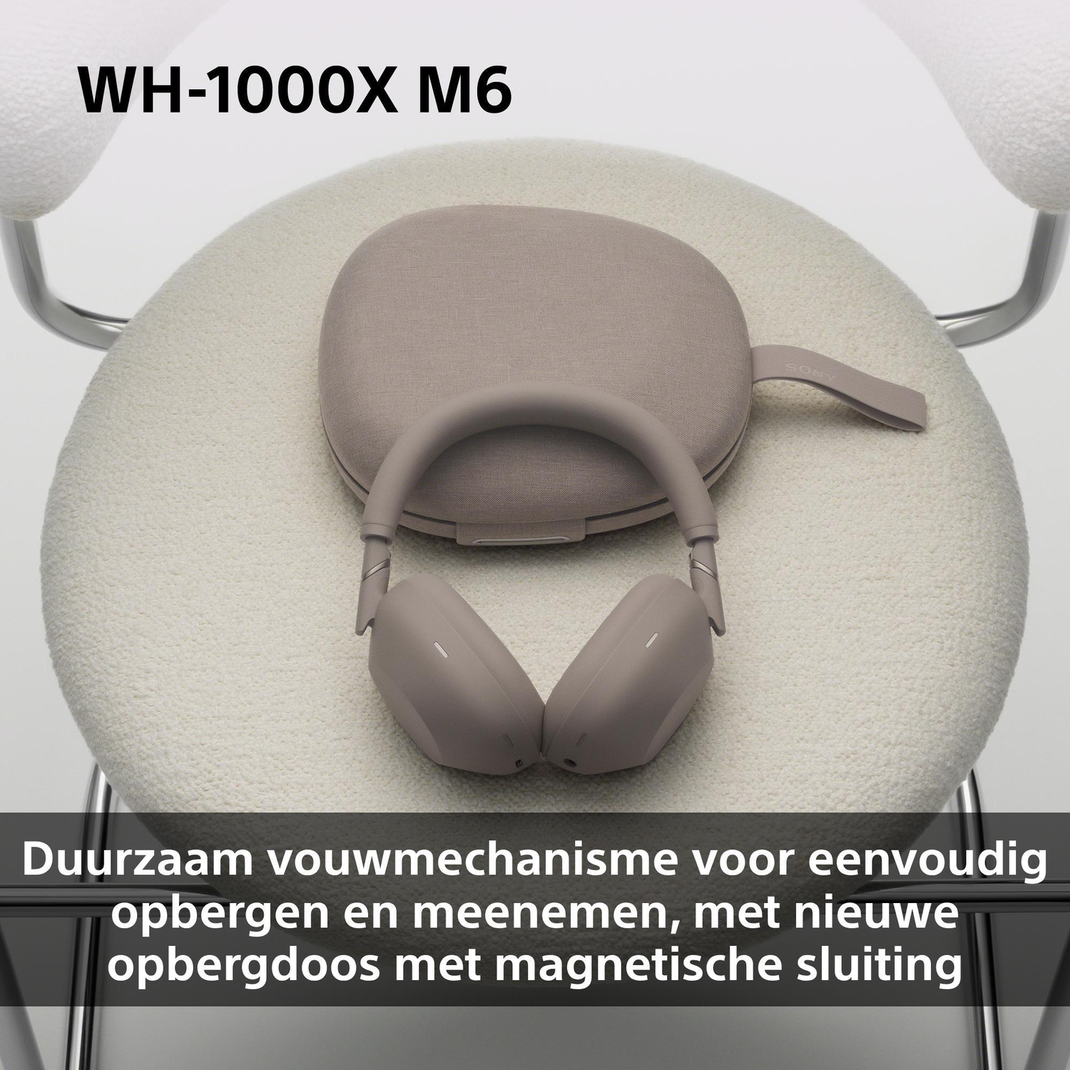 Gray headphones with case on a cream-colored chair.