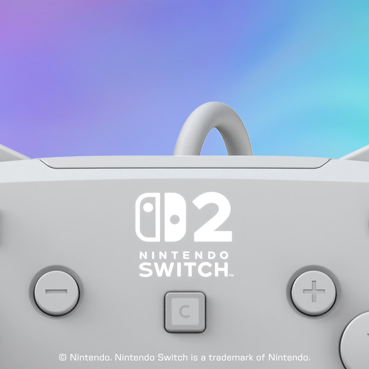 Manette grise Nintendo Switch 2 sur fond arc-en-ciel.