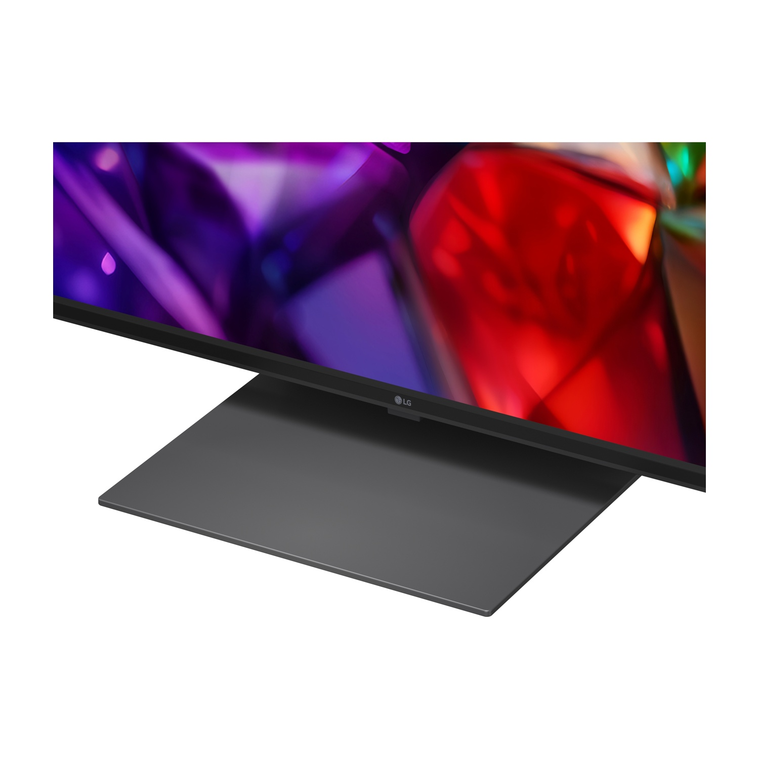 Una TV LG moderna con una base grigia elegante e uno sfondo astratto colorato.