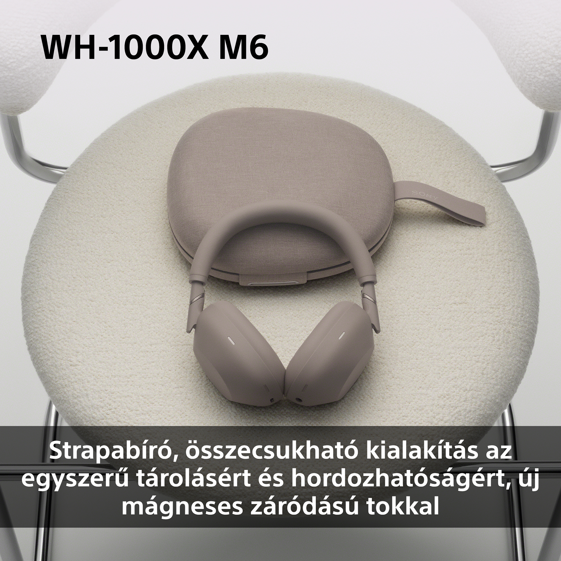 Szürke fejhallgató, hozzáillő tokkal, krémszínű széken.