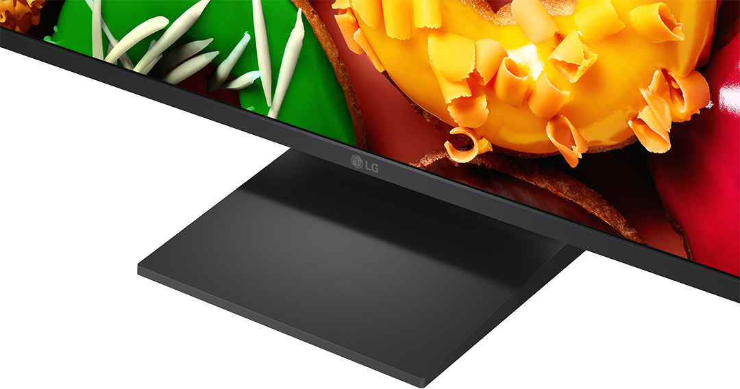 LG monitor részlete, sárga és zöld elemekkel díszített absztrakt művészettel.