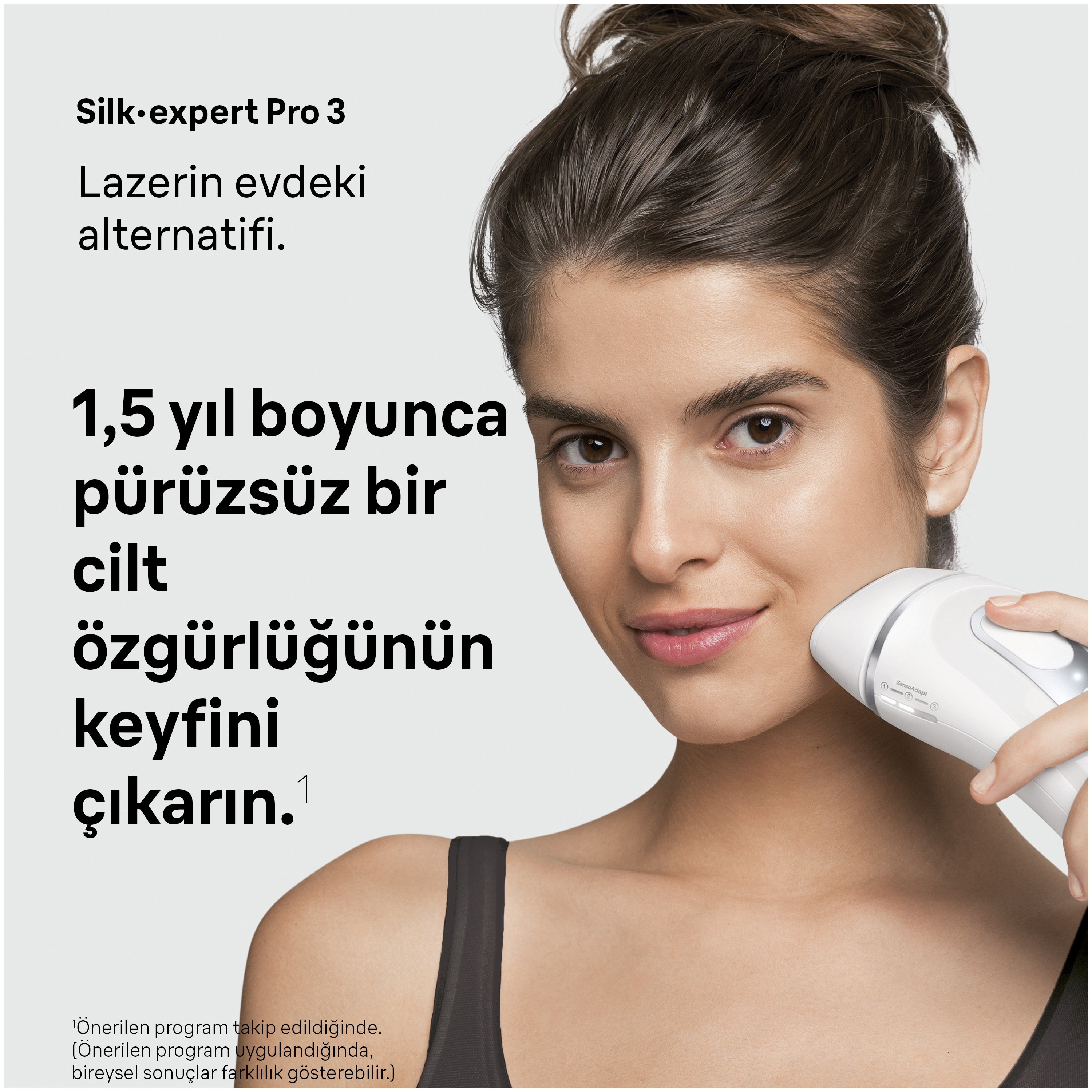 Bir kadın yüzünde beyaz bir IPL epilasyon cihazı kullanıyor.