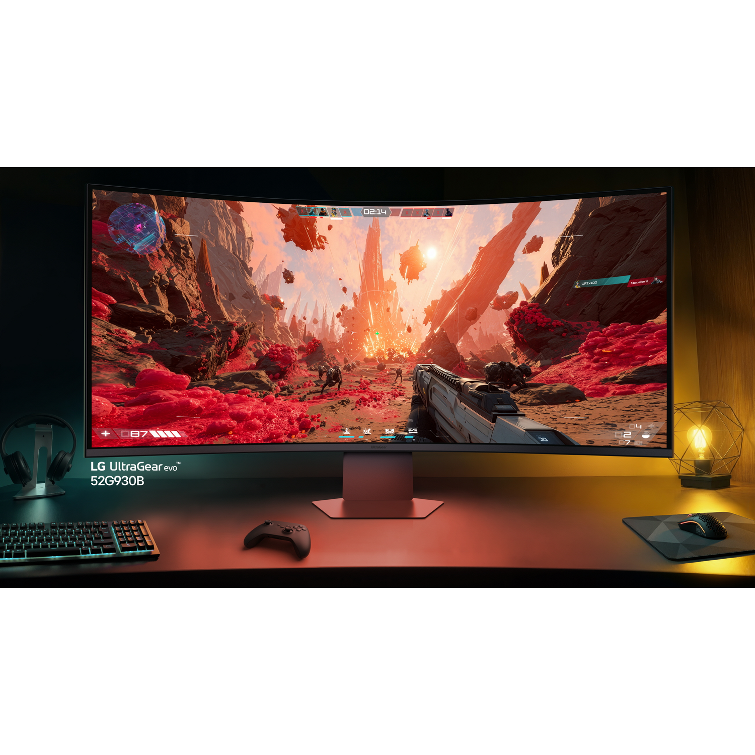 Curved LG monitor displaying a video game with red terrain and alien structures.