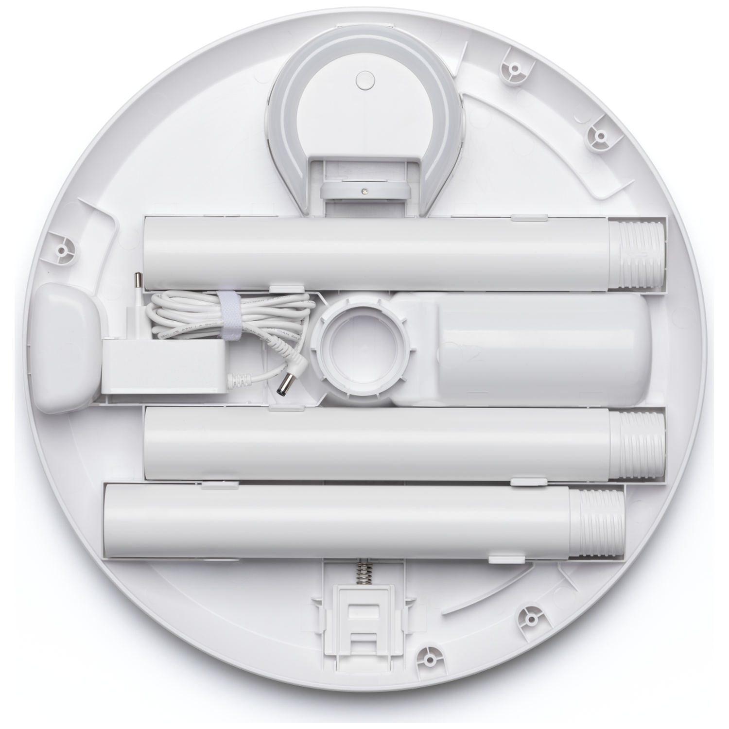 White tubes and a power adapter are arranged on a white base.