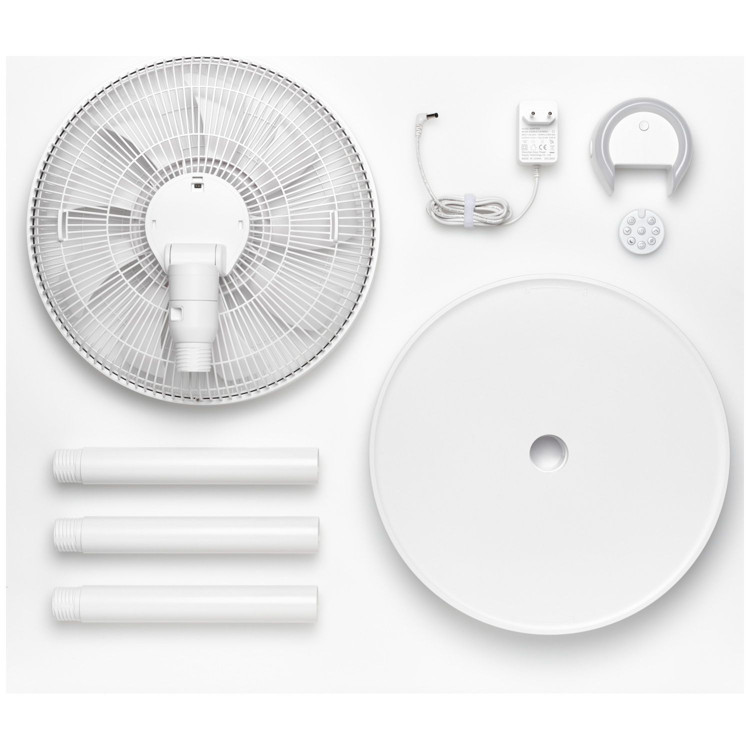 White standing fan parts: rotor, base, poles, power adapter, remote control.