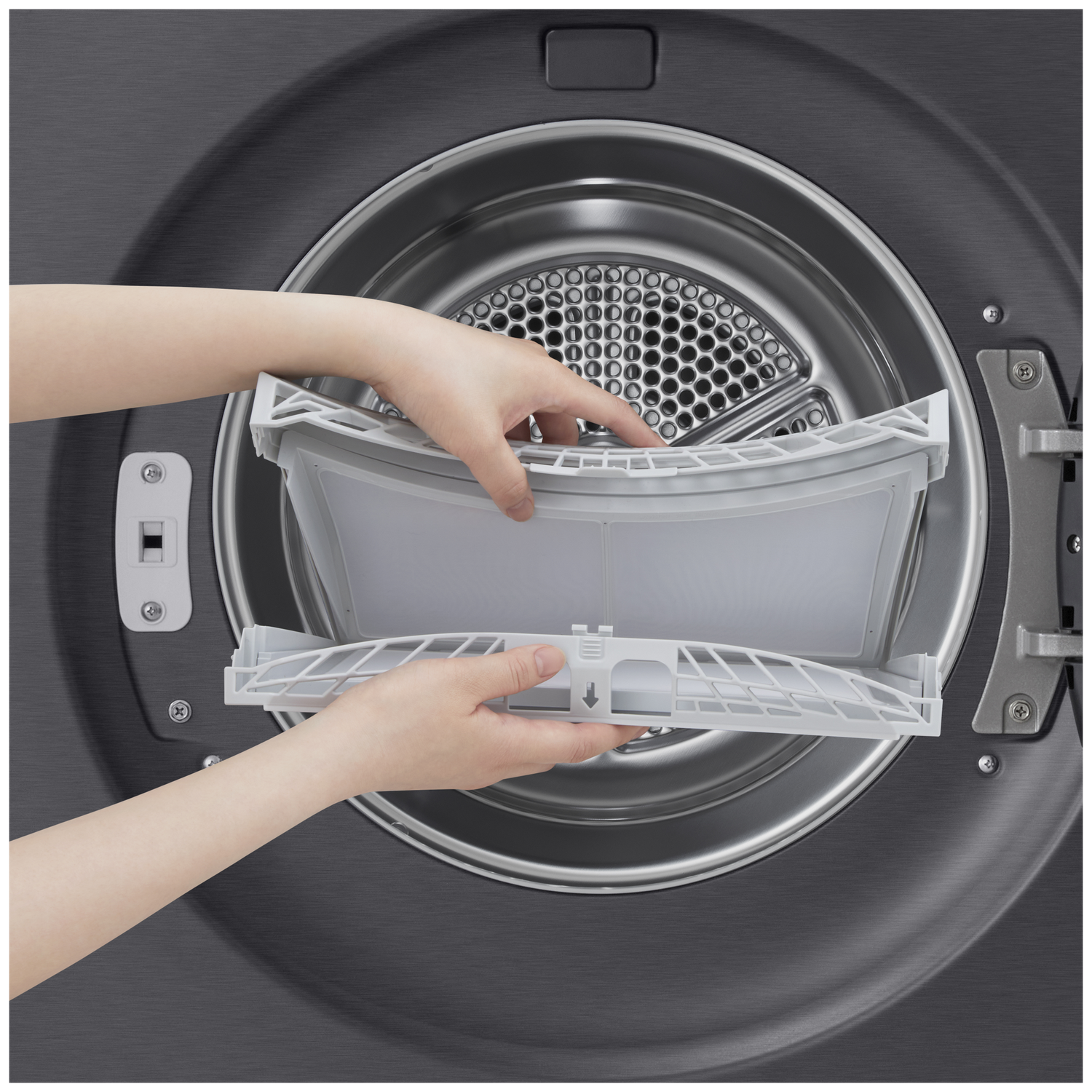 Hands removing a gray lint filter from inside a clothes dryer.