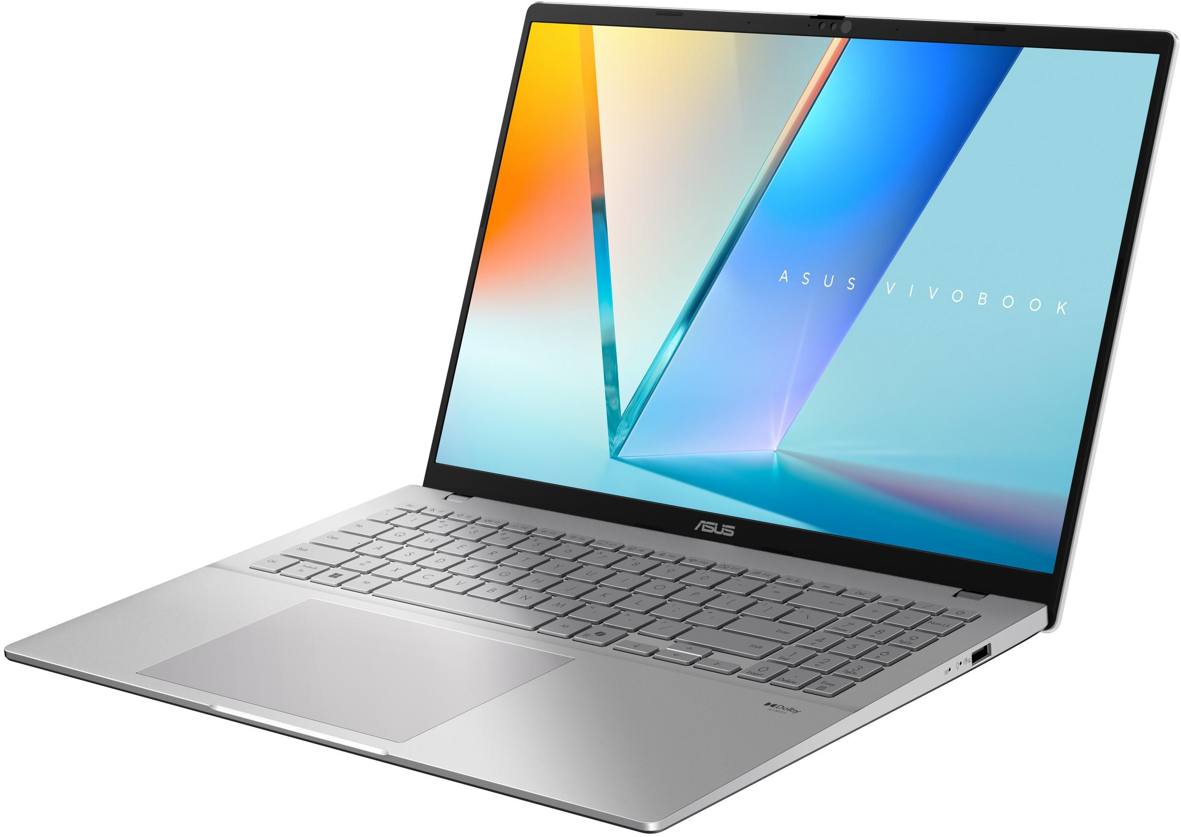 Ezüst ASUS Vivobook laptop világító billentyűzettel és absztrakt háttérképpel.