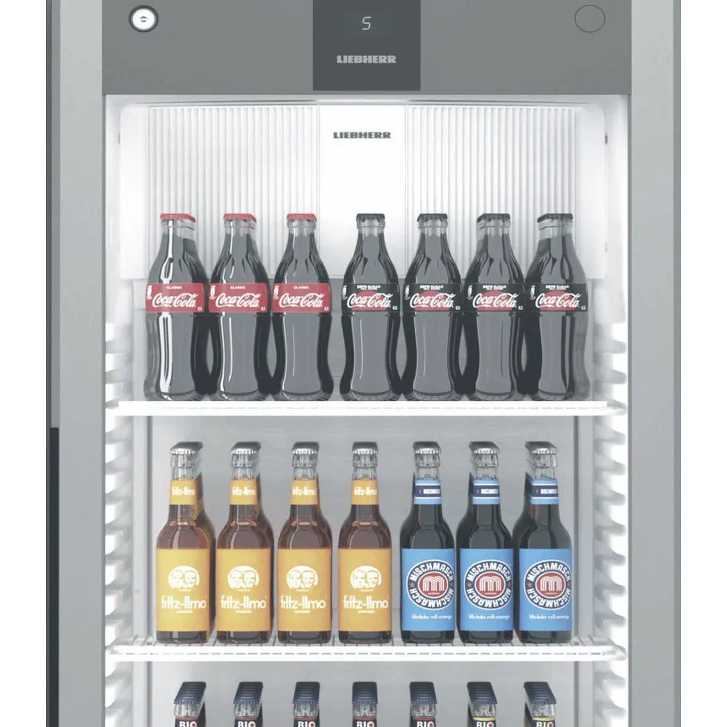 A refrigerator with multiple shelves filled with drink bottles, including Coca-Cola and sodas.