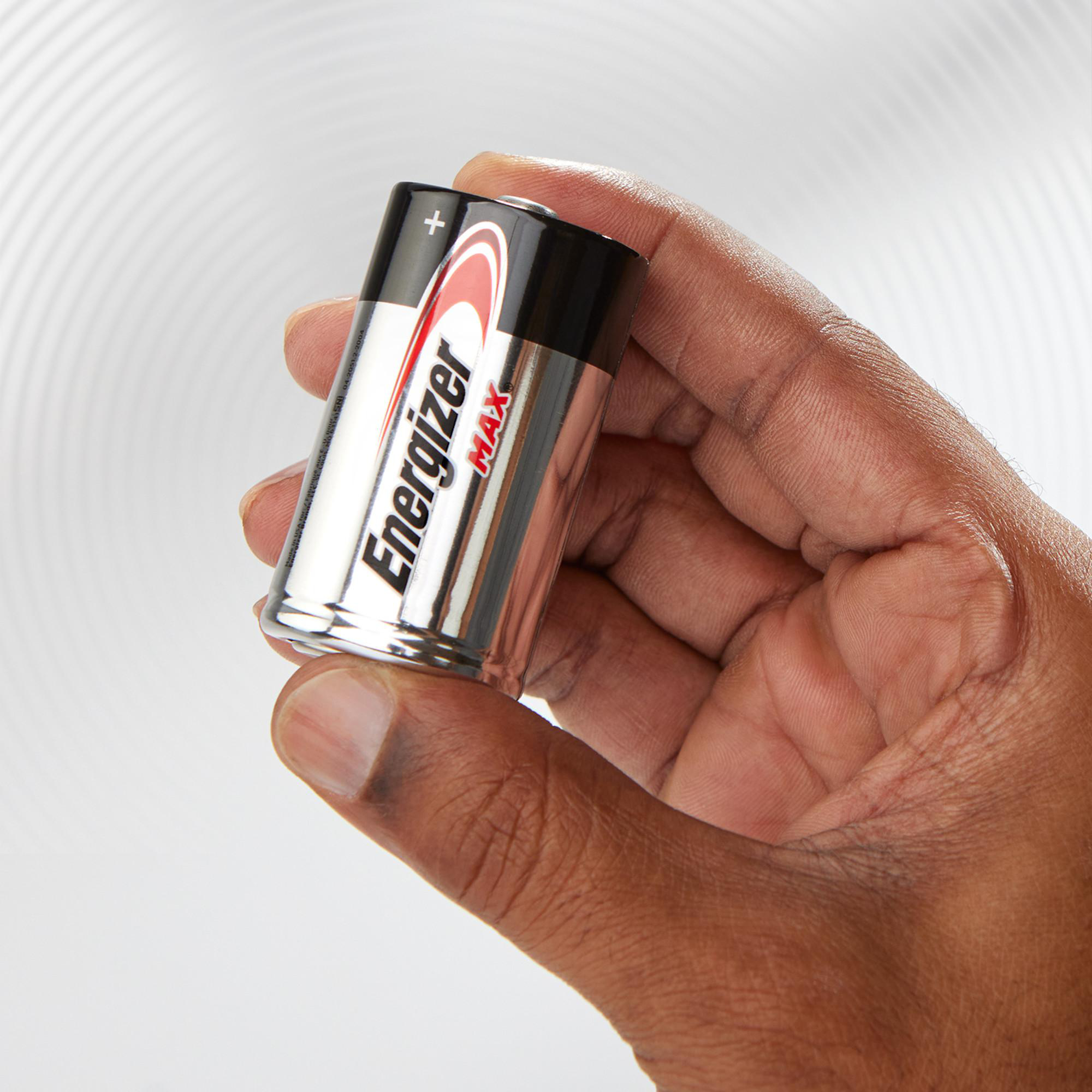 Eine Hand hält zwei silberne Energizer Max Batterien mit schwarzem Kopf.