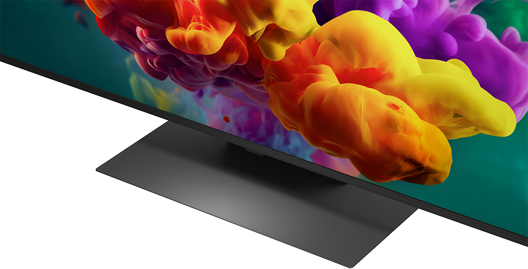 Egy modern TV színes absztrakt képernyővédővel, elöl fekete állvánnyal.
