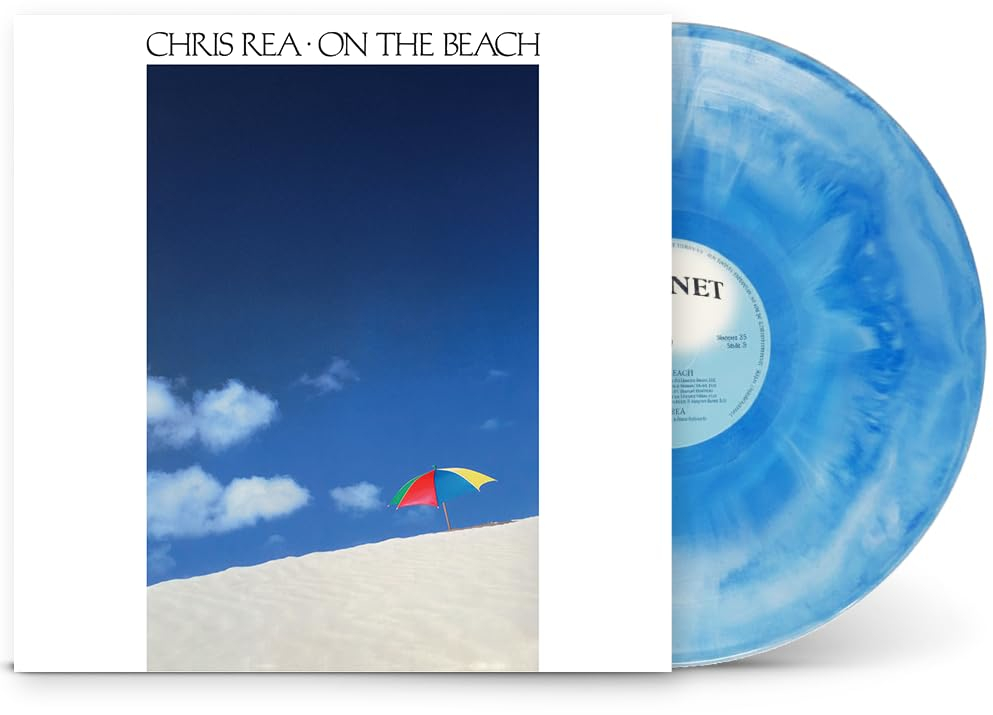Chris Rea album borító színes esernyővel homokdűnén kék ég alatt.