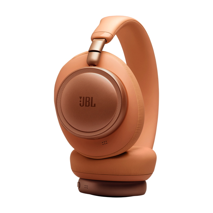 Auriculares JBL naranjas con detalles en oro rosa sobre fondo negro.