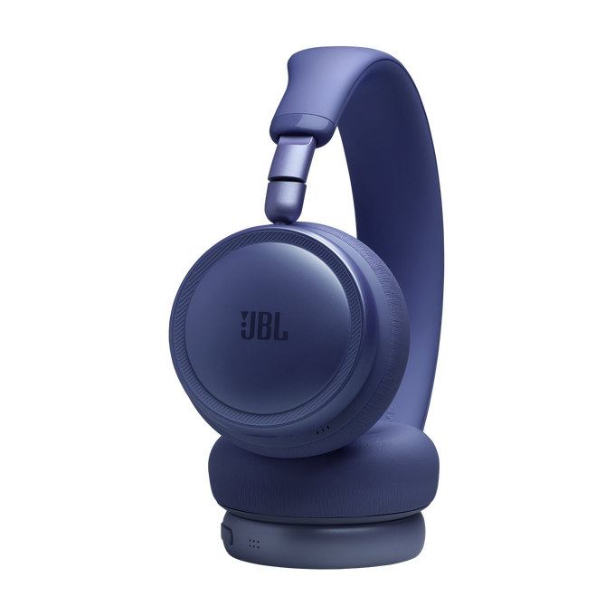 Unos auriculares JBL morados sobre fondo negro.