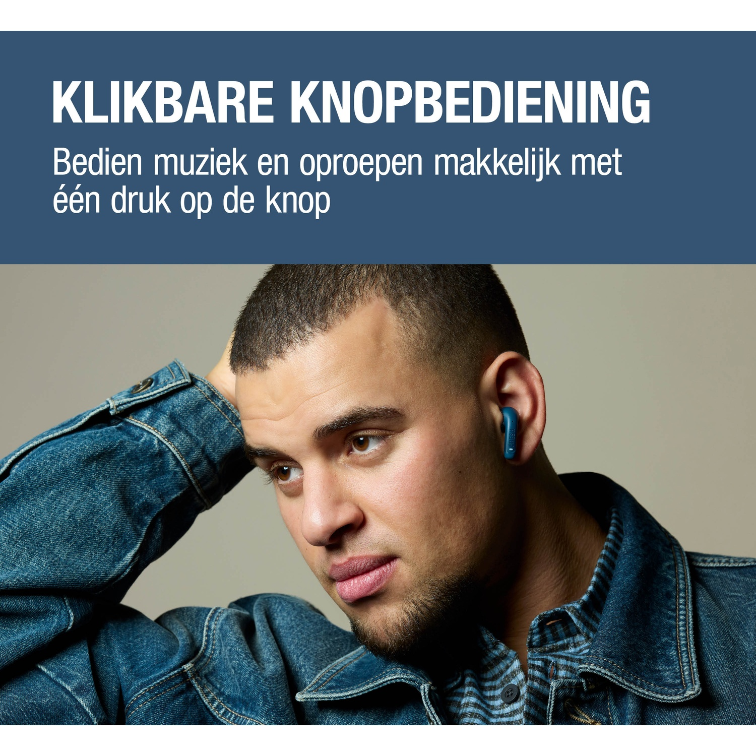 Man met blauwe oordop, spijkerjack, grijze achtergrond.