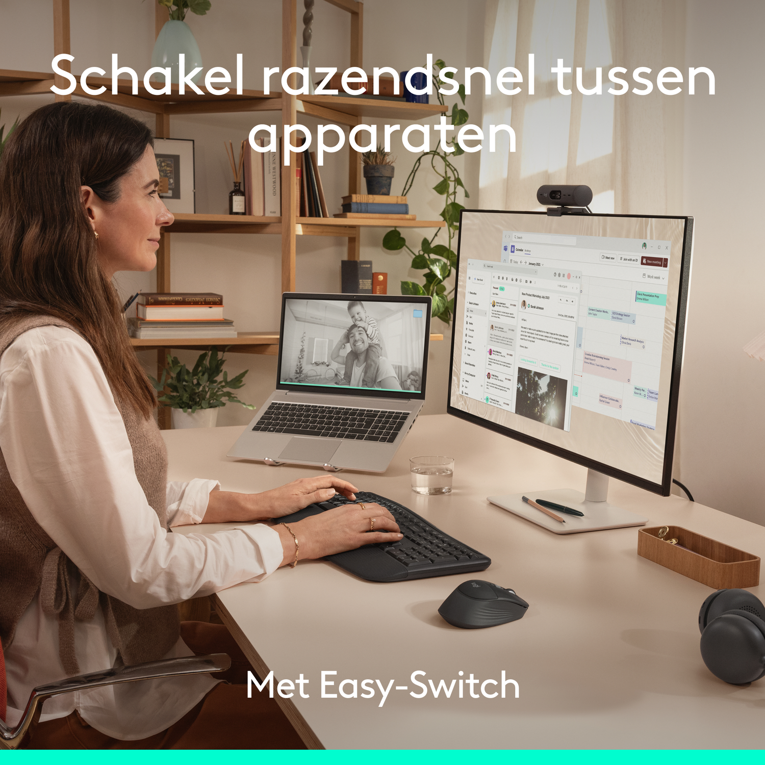 A woman works at a desk with two monitors, a keyboard, and a mouse.