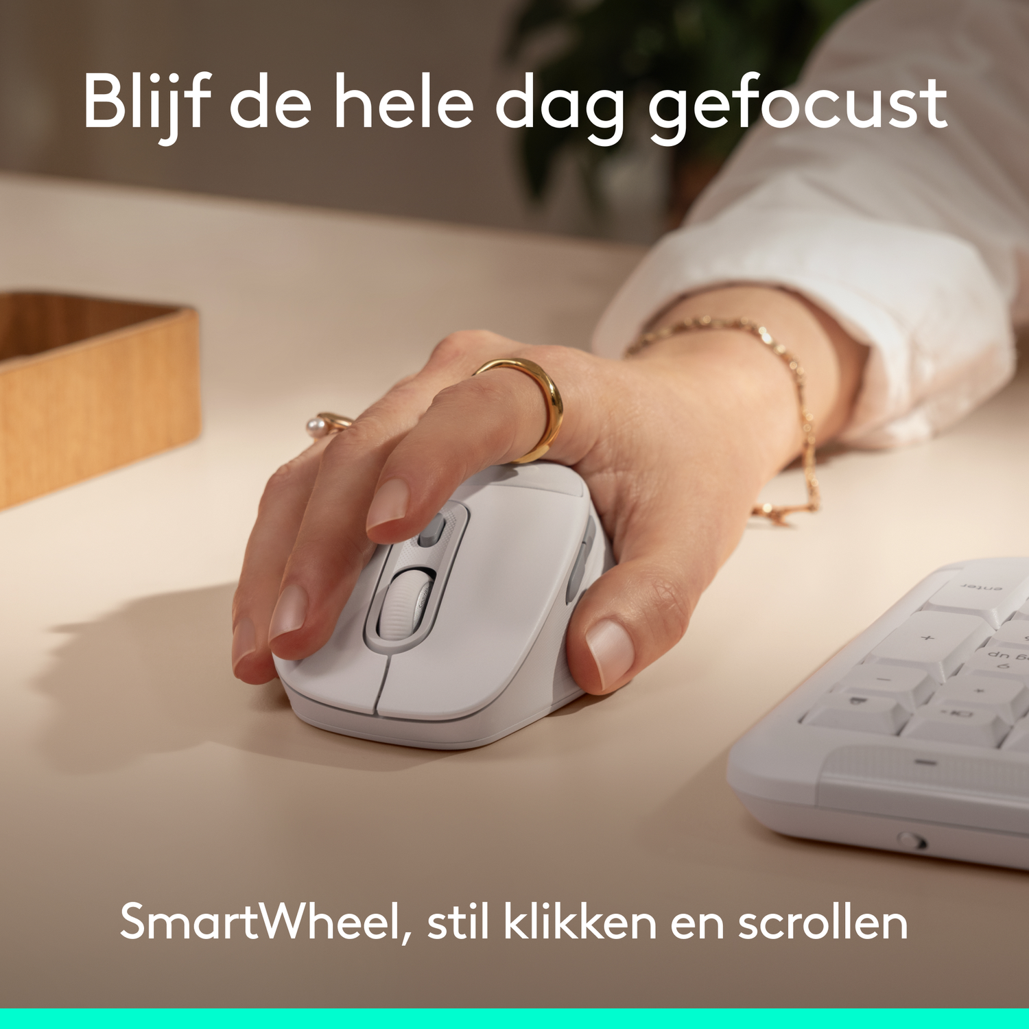 White mouse with SmartWheel being operated by a hand, next to a keyboard.