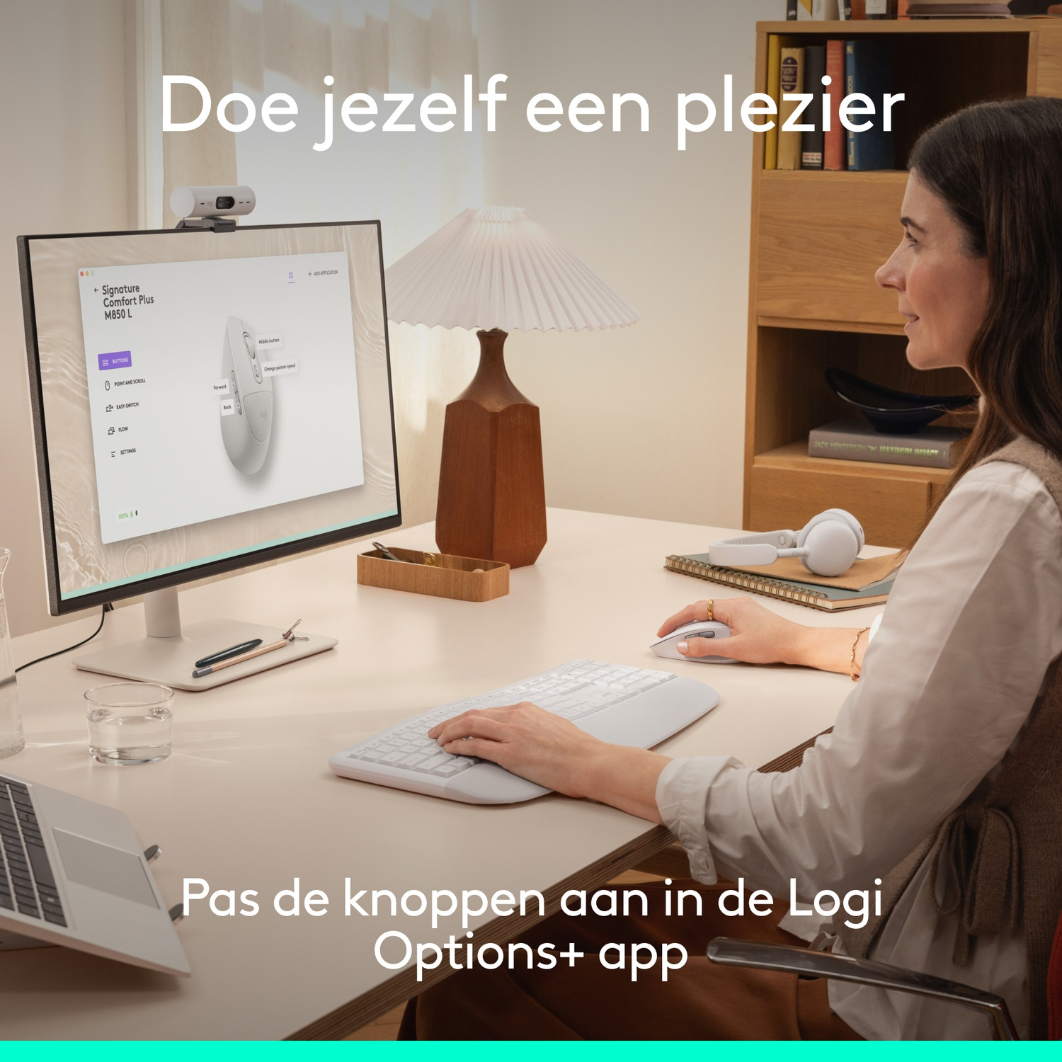 Woman at a desk with mouse, keyboard, and computer.