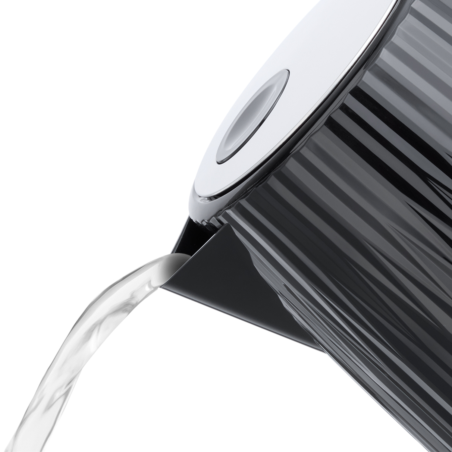 Water pours from a black kettle with a ribbed pattern.