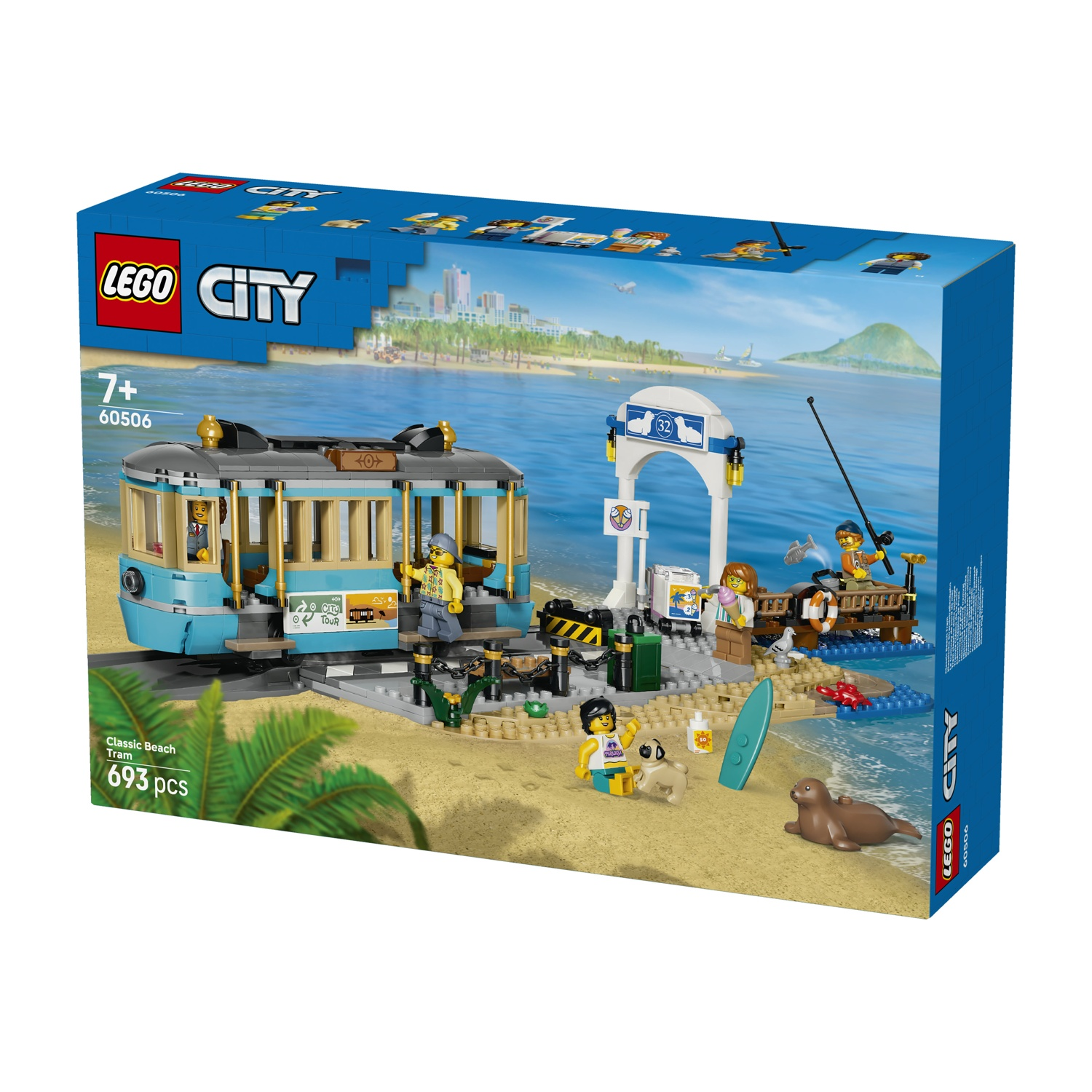 Un set Lego con tram da spiaggia, figure, un cane e una foca vicino al mare.
