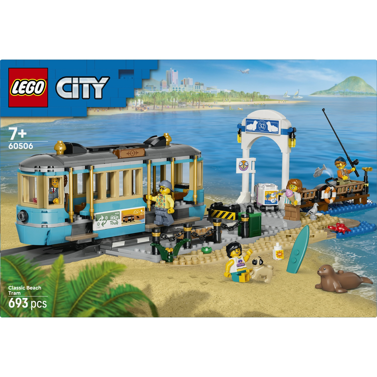 Un set Lego con un tram blu su una spiaggia, con figure e una foca.