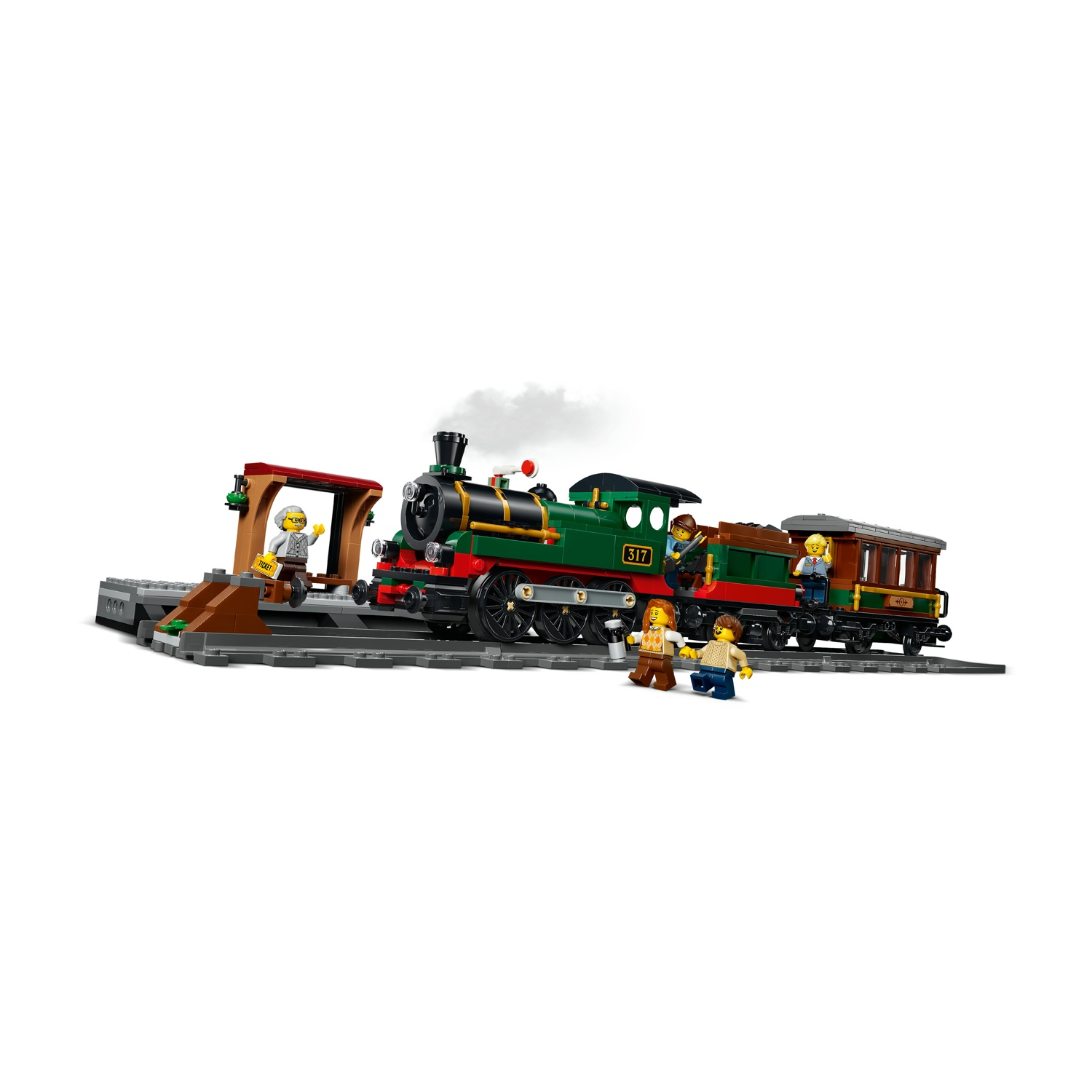 Treno Lego verde con passeggeri su una banchina di stazione con biglietteria.