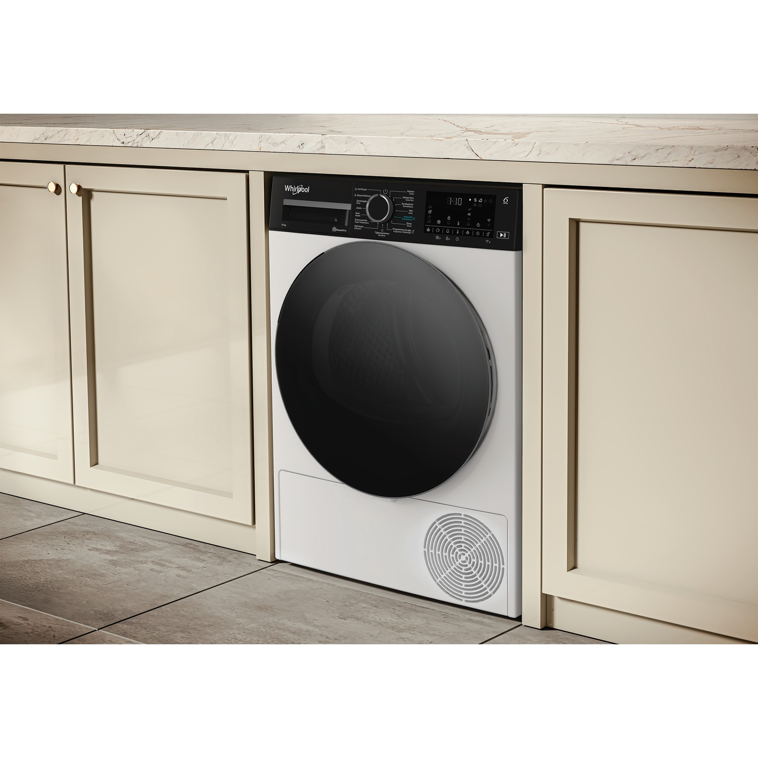 A white Whirlpool dryer is positioned between cream cabinets on a tiled floor.