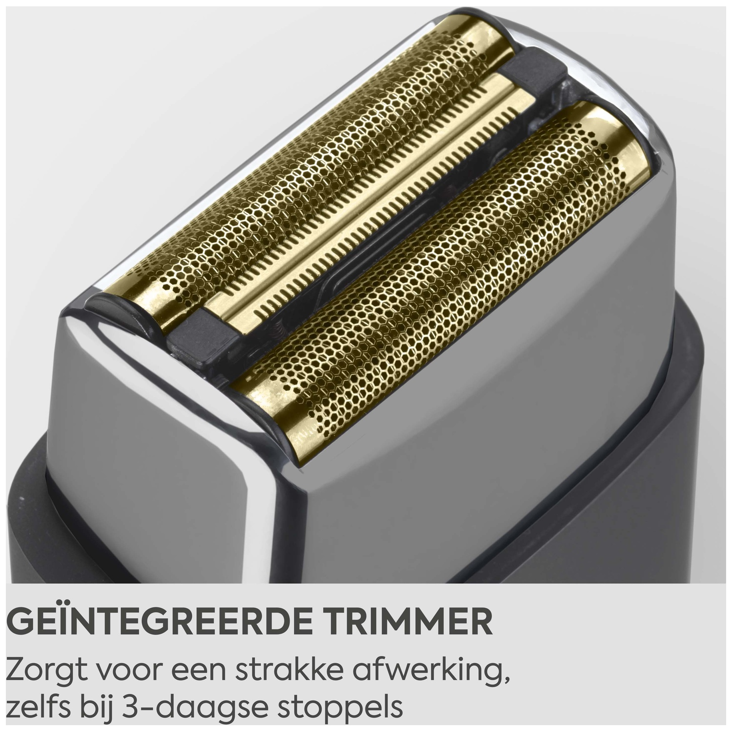 Close-up of a shaver head with gold foils and an integrated trimmer.