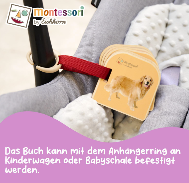 Ein golden Retriever-Bild auf Holz, befestigt an einem Kinderwagen mit rotem Band.