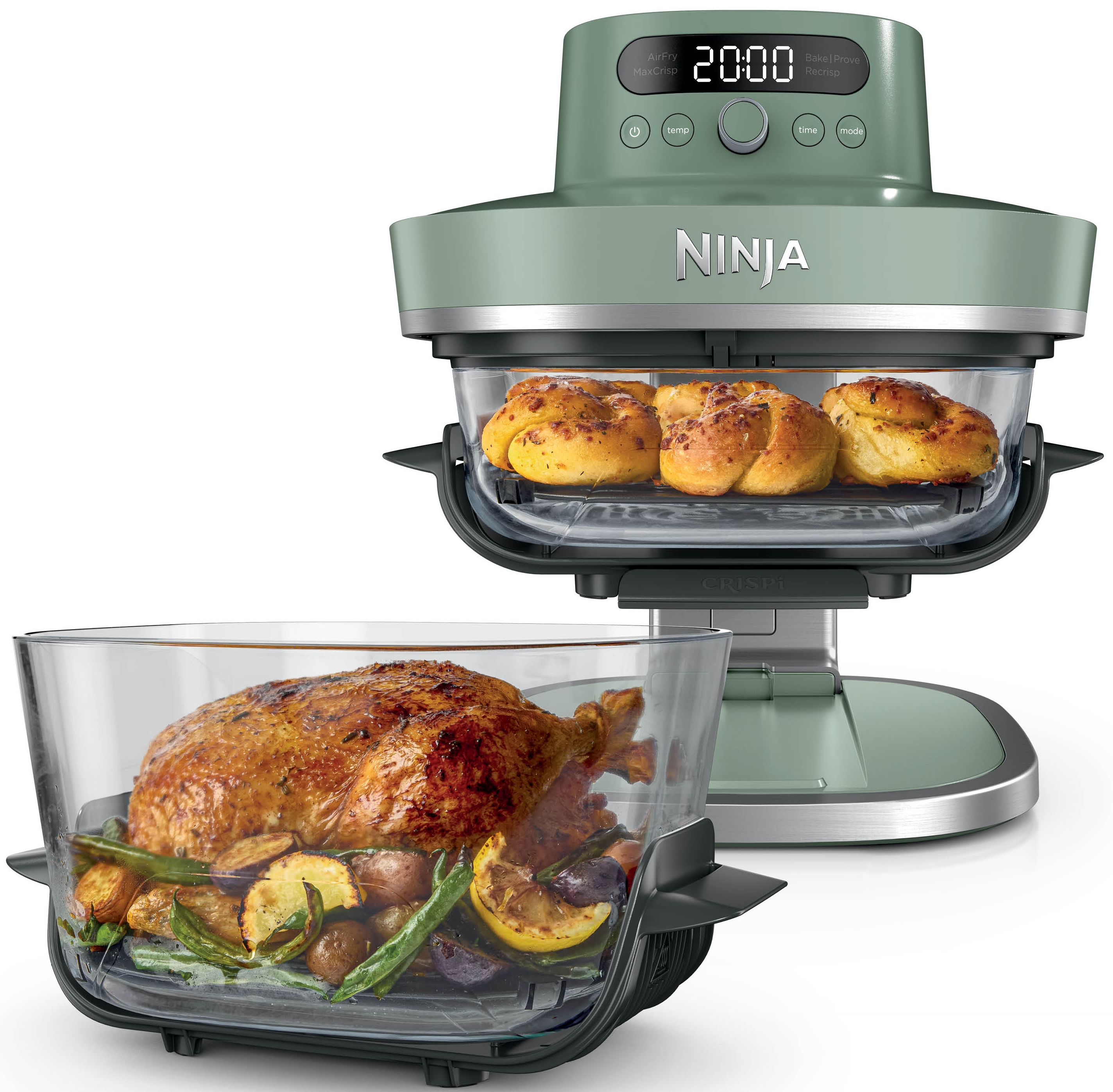 Ninja Foodi vert avec poulet rôti et légumes, et petits pains dans le compartiment supérieur.