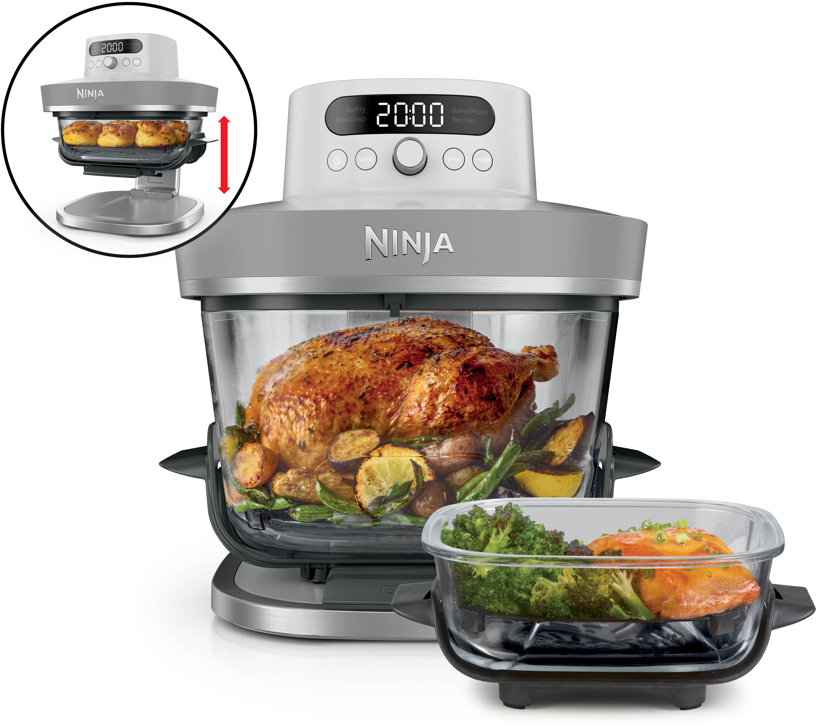 Un four Ninja avec un poulet rôti et des légumes, à côté un plat en verre avec du saumon et du brocoli.