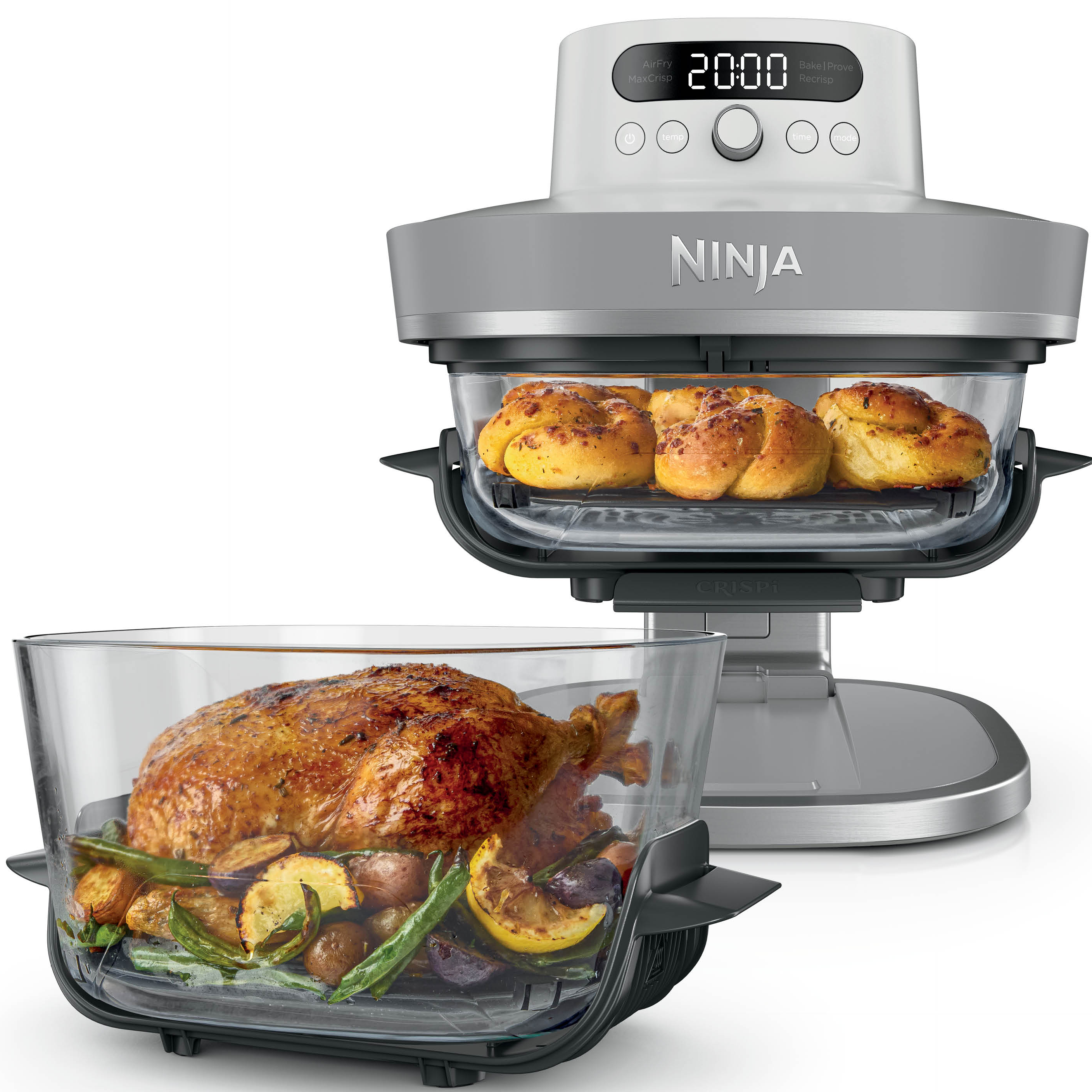 Un four Ninja avec un poulet rôti et des légumes dans le panier inférieur et des petits pains dans le panier supérieur.