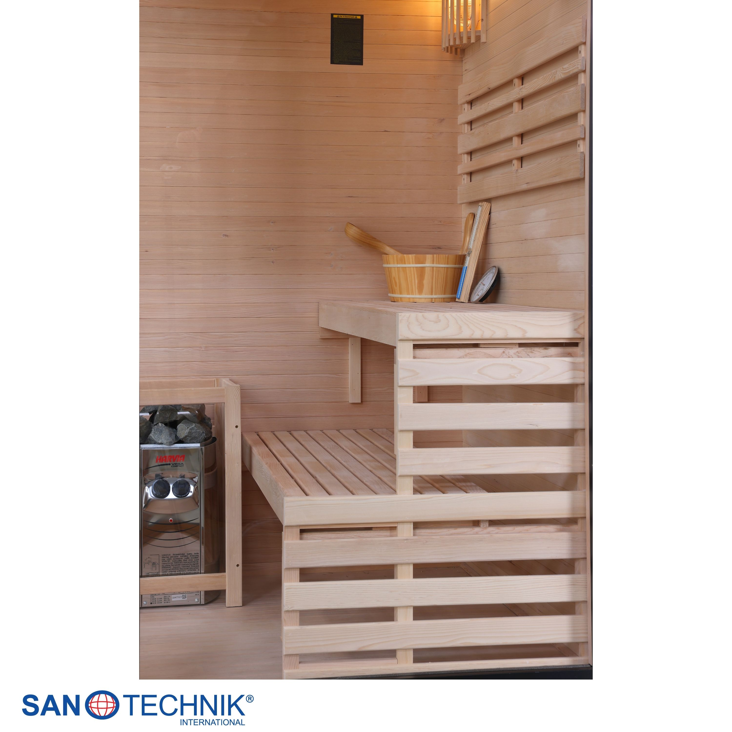 Eine Sauna aus Holz mit Bänken, einem Ofen, Steinen und Zubehör wie einem Eimer.