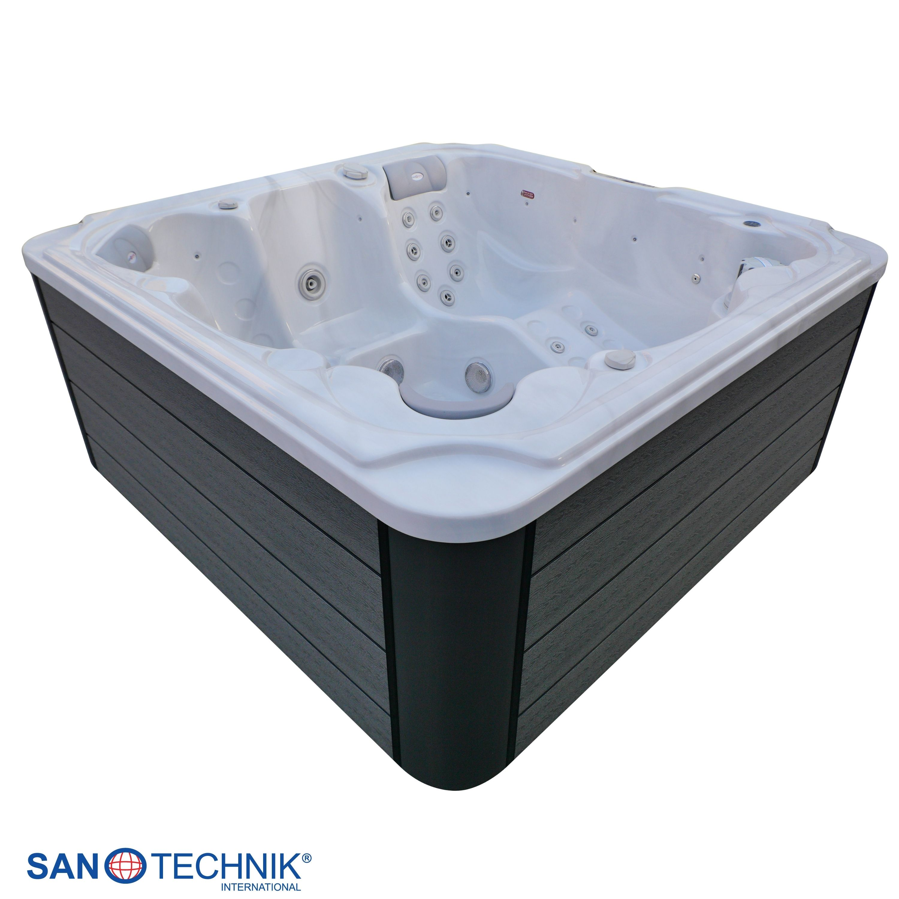 Ein weißer Whirlpool mit dunkler Verkleidung und Düsen.