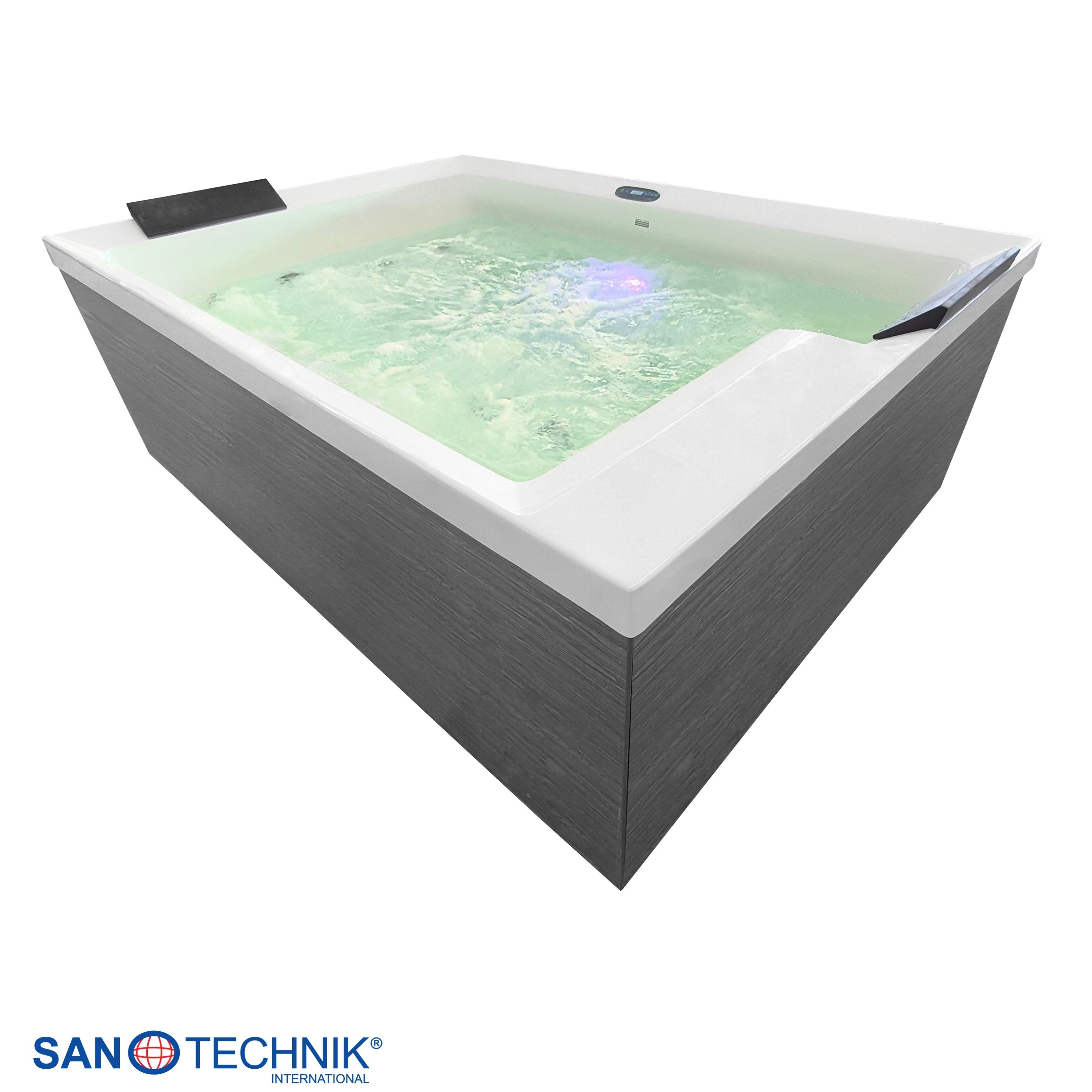 Ein modernes, rechteckiges Whirlpool mit grauem Holzimitat-Rand und beleuchtetem Wasser.