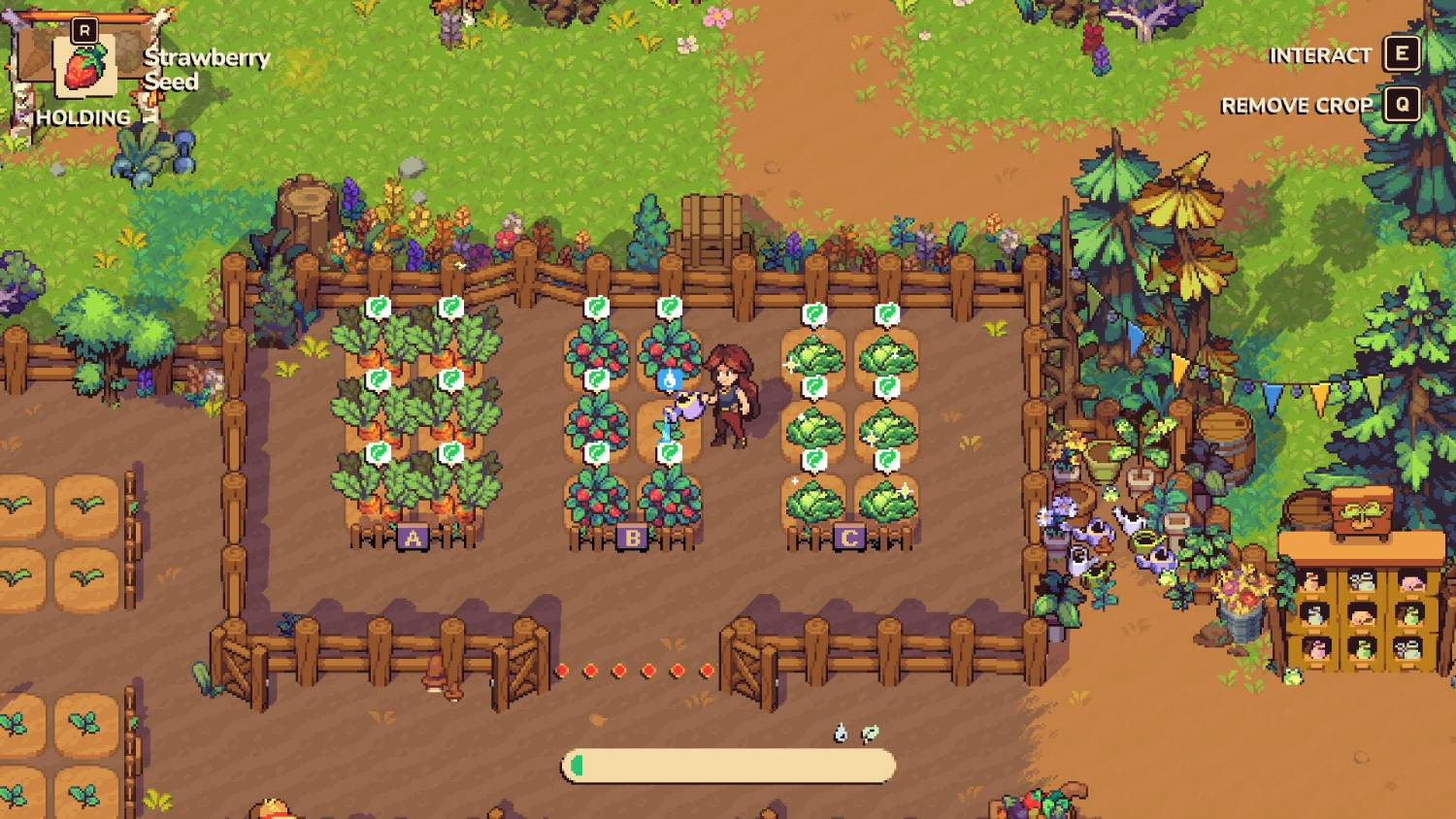 Una persona riega cultivos en un jardín con zanahorias, fresas y repollo.
