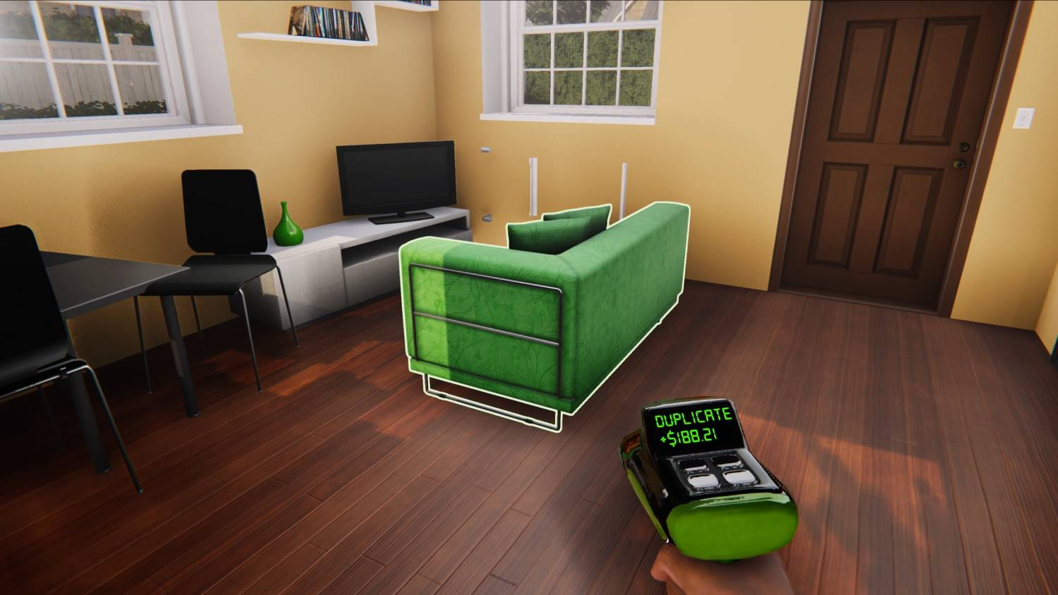 Un sofá verde está en el centro de una sala con piso de madera. Un escáner está al frente.