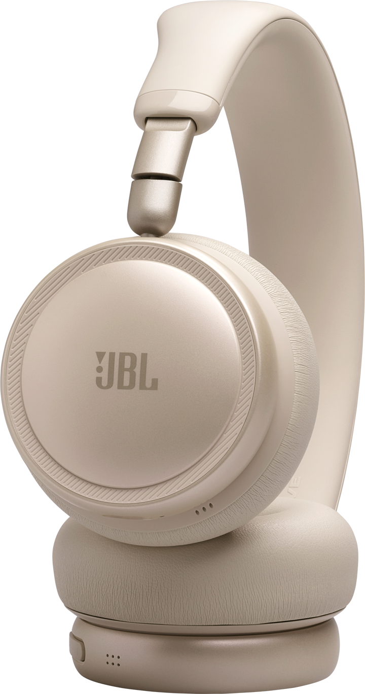 Una cuffia JBL beige su sfondo nero.
