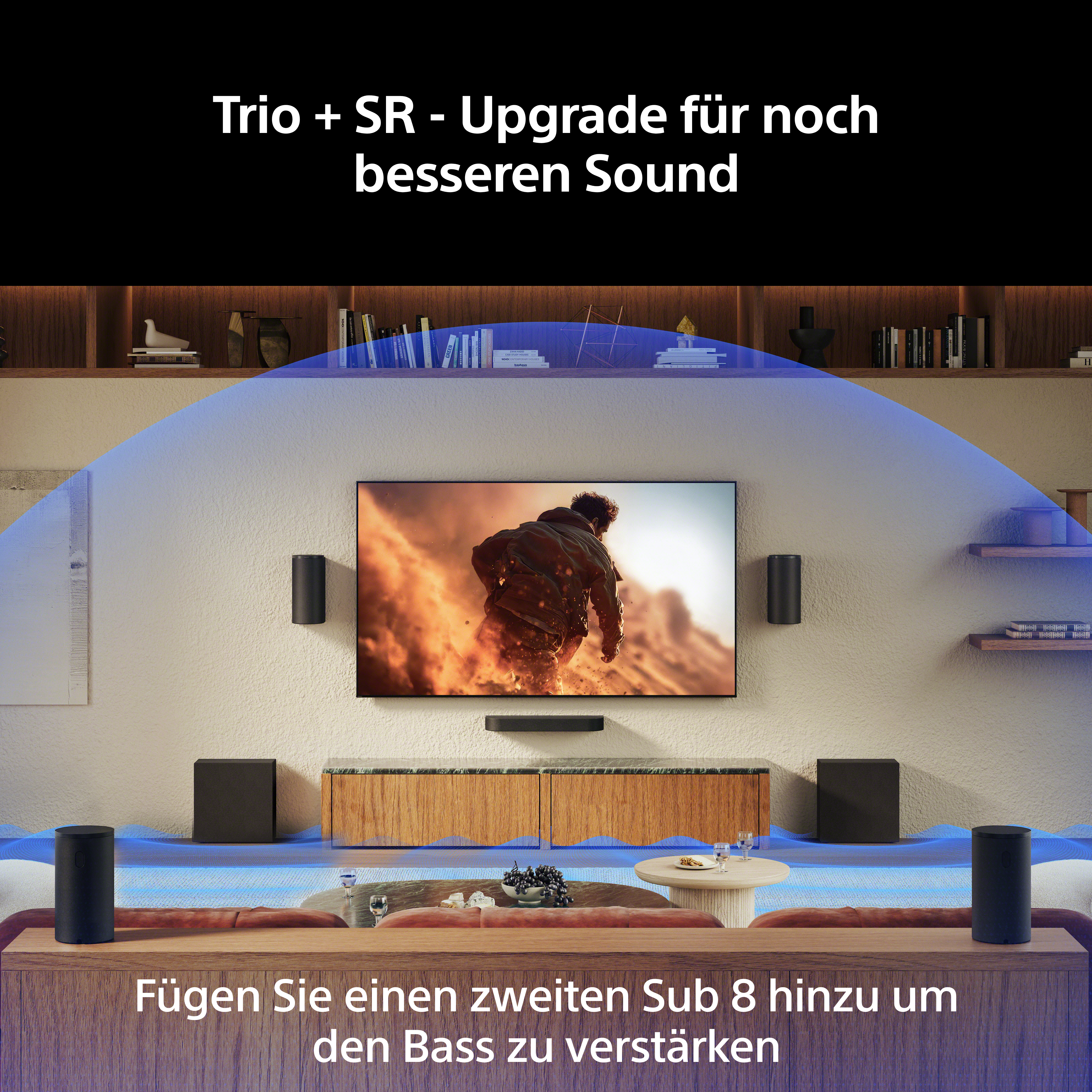 Ein Wohnzimmer mit Fernseher, Lautsprechern und Subwoofern.