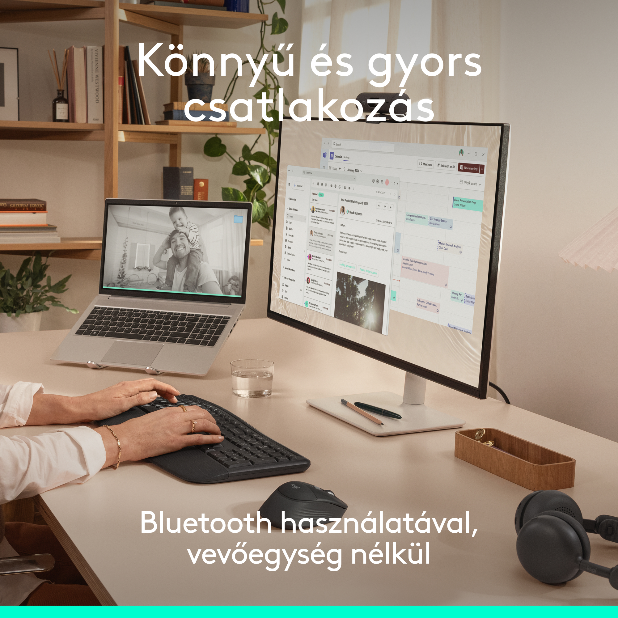 Íróasztal laptopnak, monitornak, billentyűzetnek és egérnek. Férfi és gyerek látható a laptop képernyőjén.