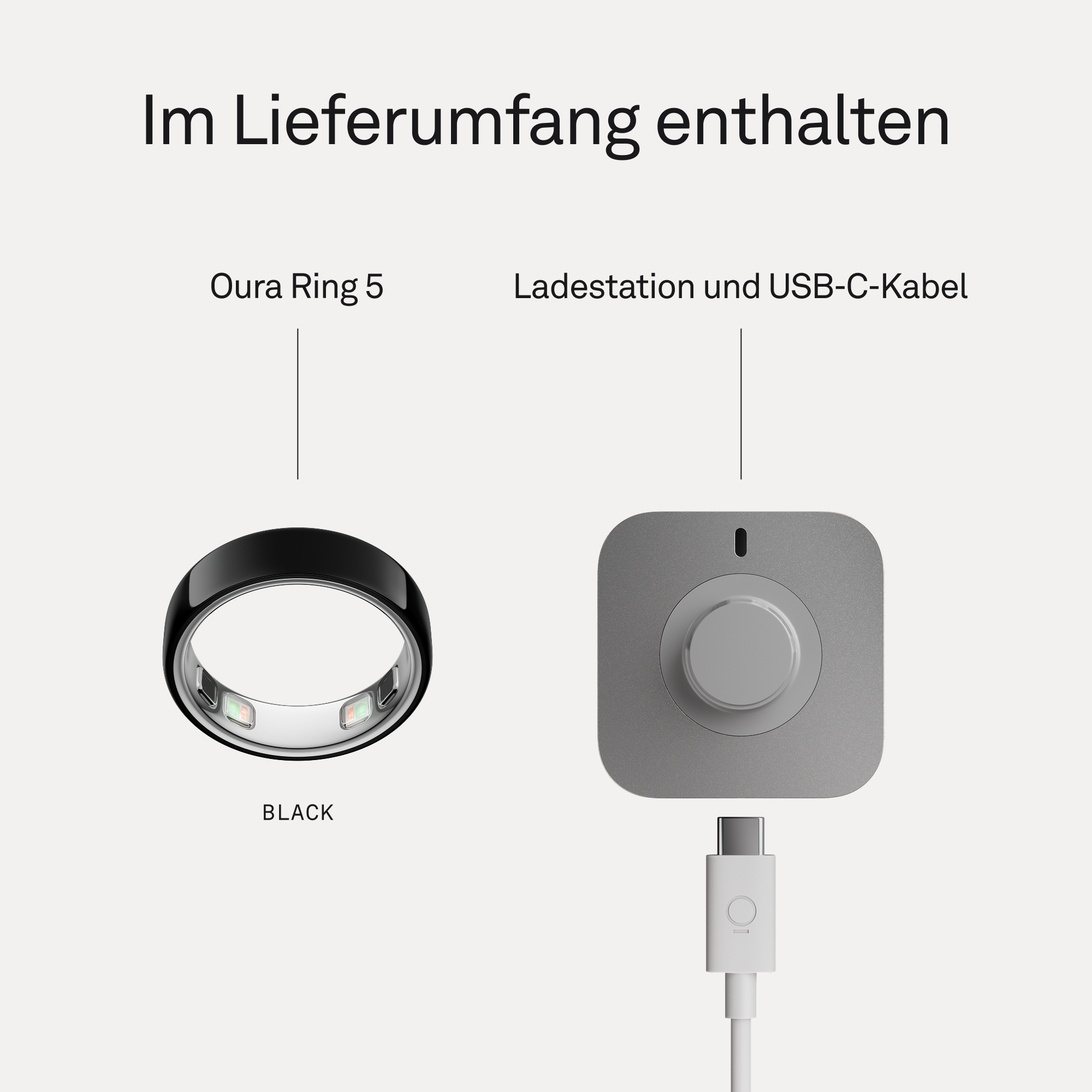 Schwarzer Oura Ring 5 neben grauer Ladestation mit USB-C-Kabel.