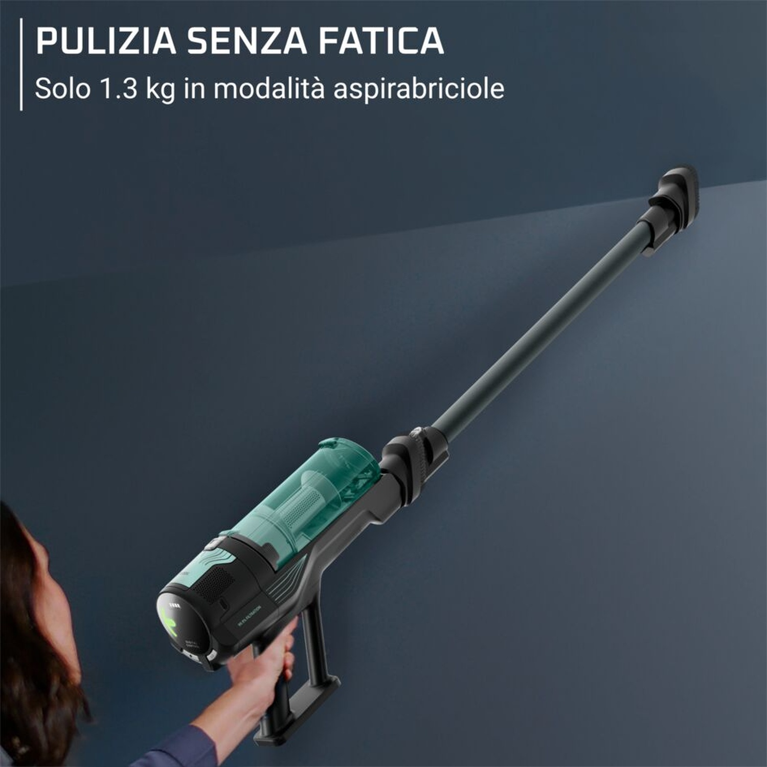 Una persona tiene un aspirapolvere senza fili leggero e turchese con tubo lungo.