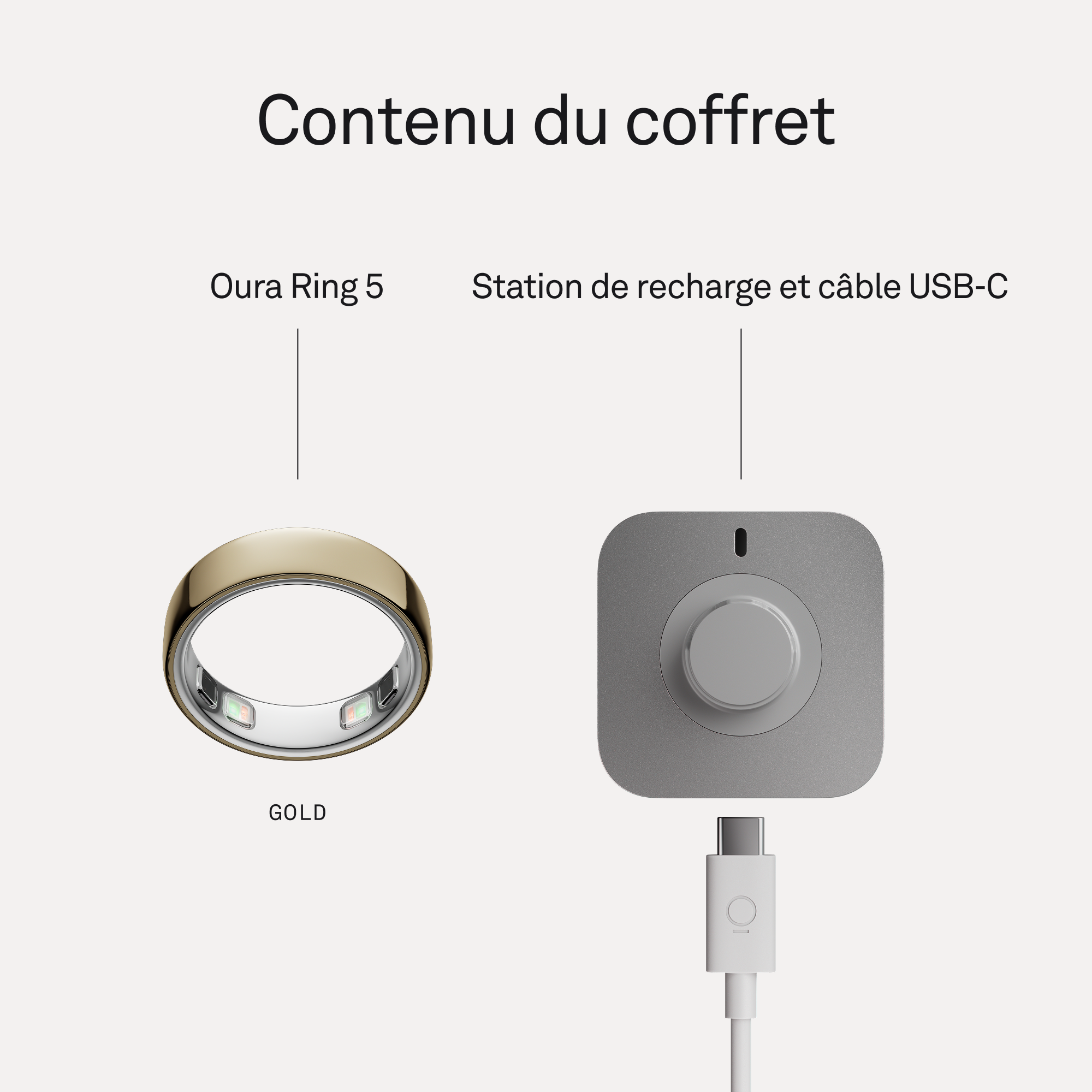 Bague Oura 5 dorée à côté d'une station de recharge grise avec câble USB-C.